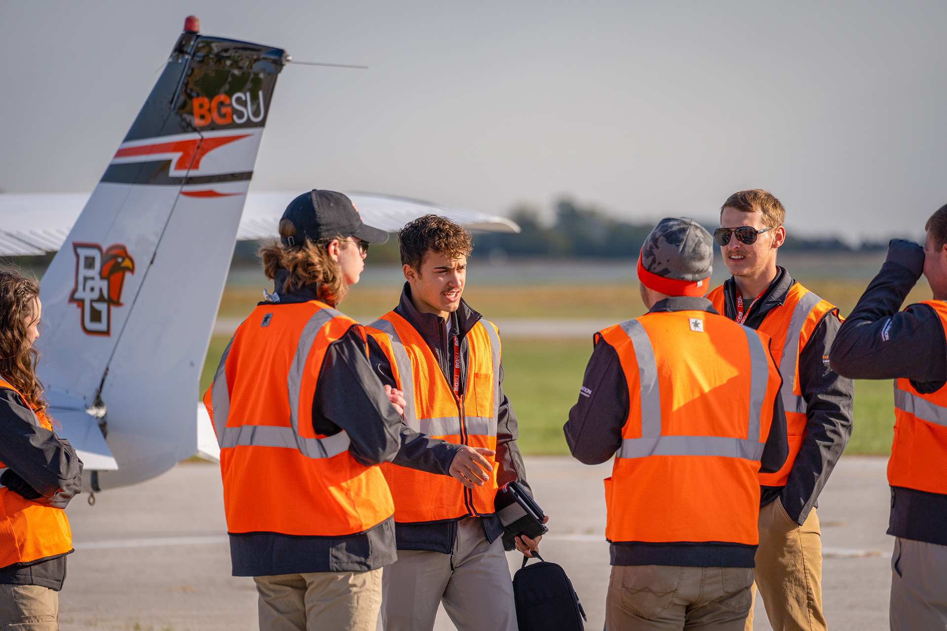 Aviation students talk to each other at the airport
