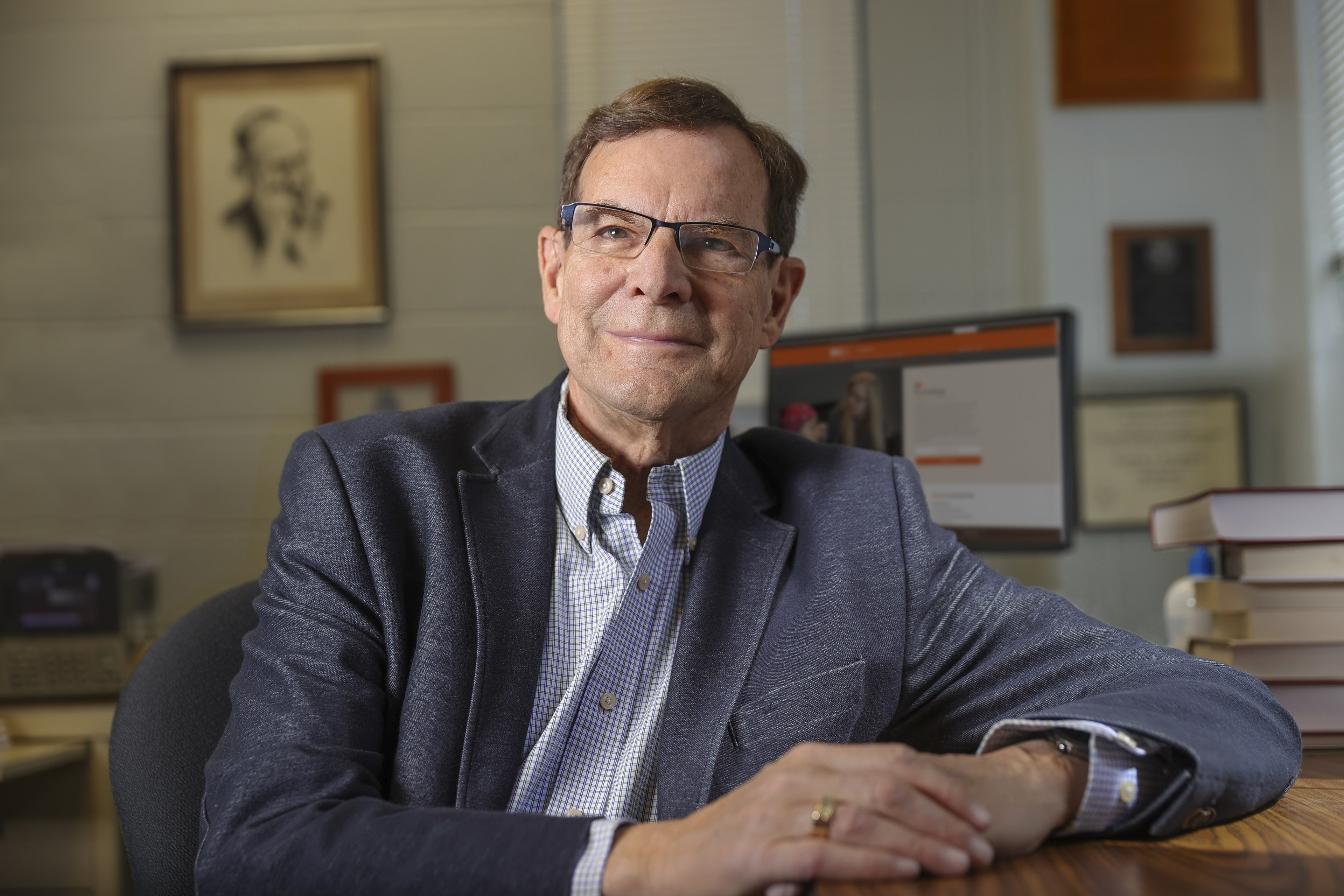 Dr. Ken Pargament smiling and leaning elbow on desk