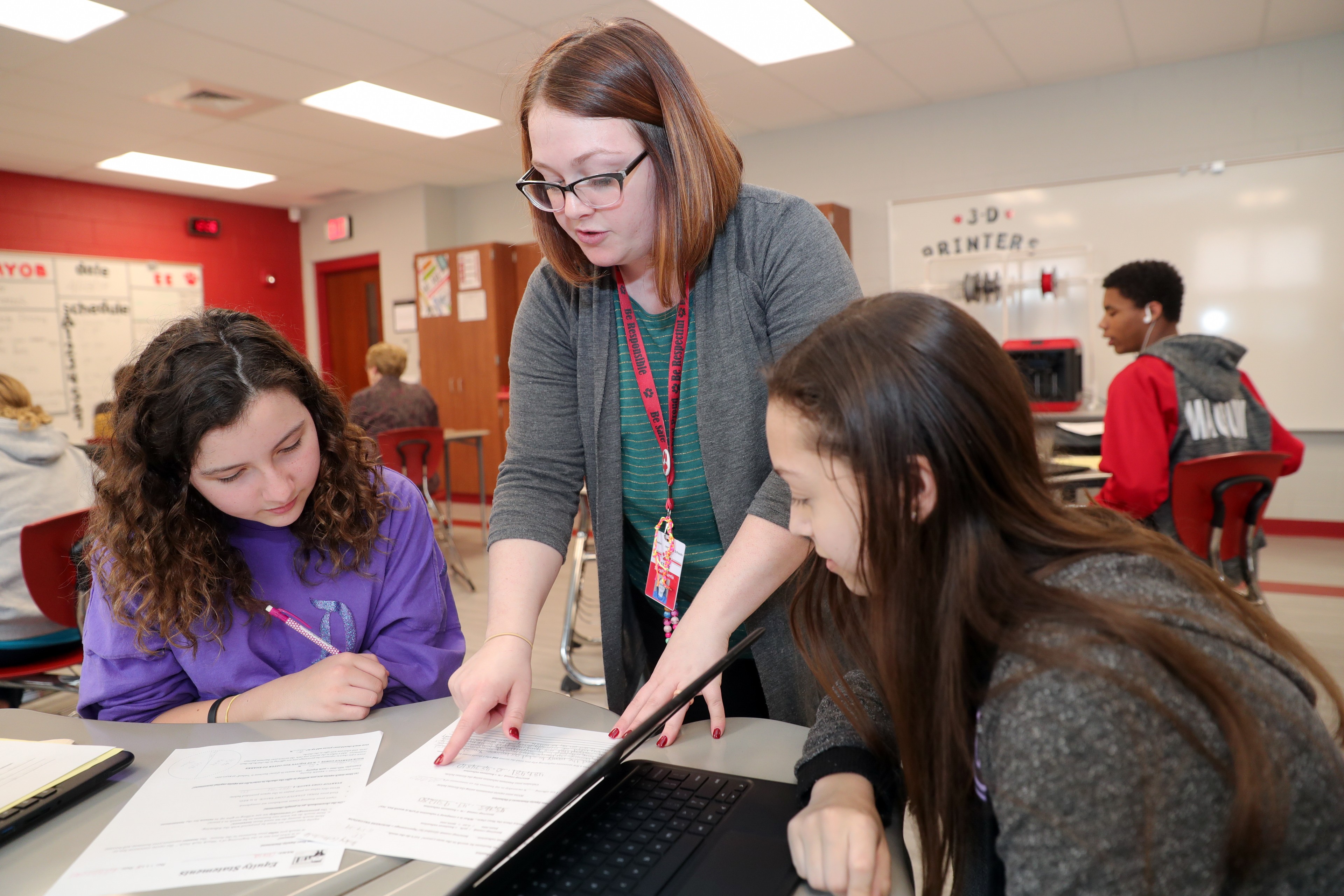 Teacher working with two students