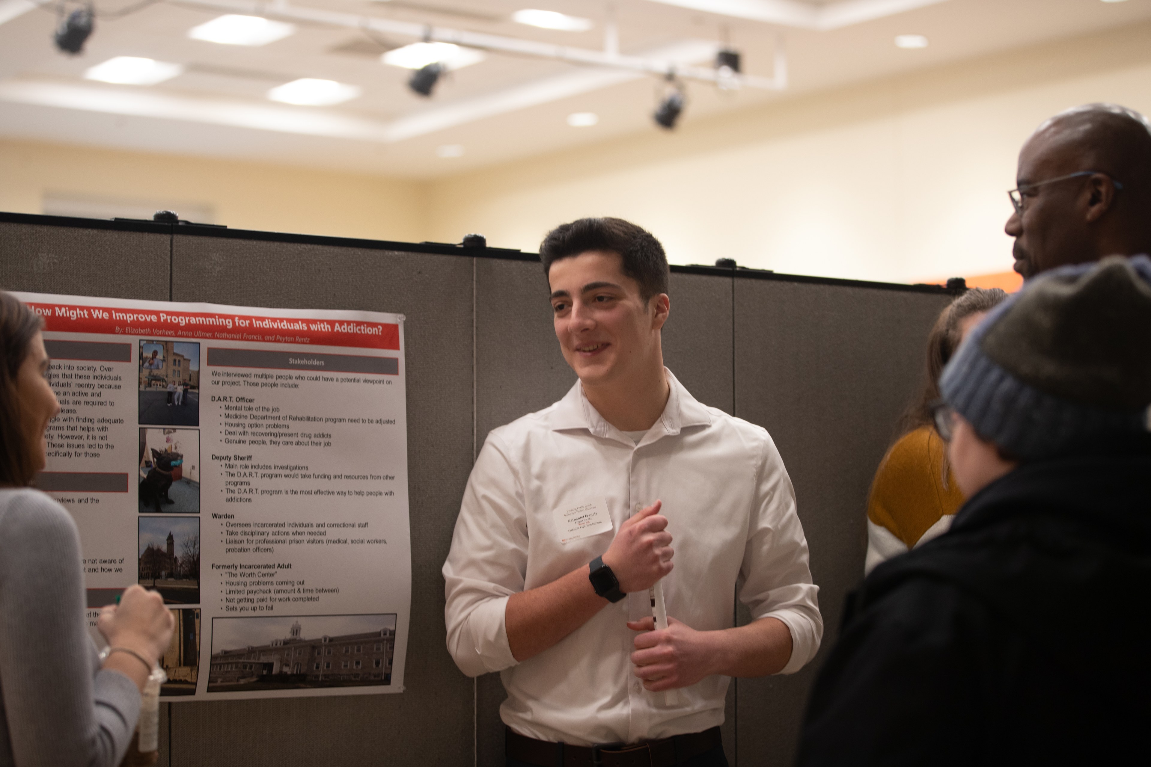 Student standing in front of their presentation