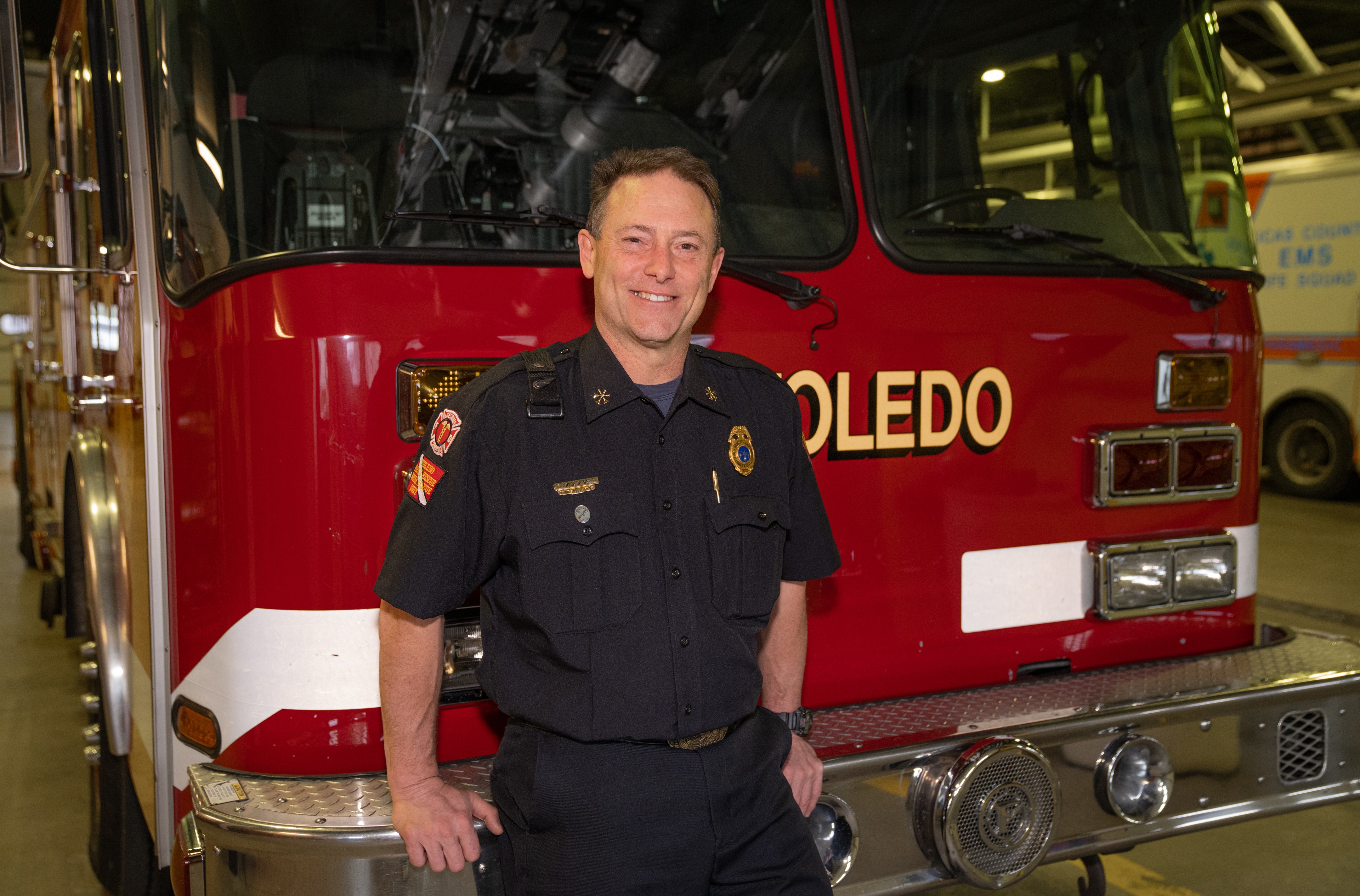 Bryce Blair leaning on a firetruck