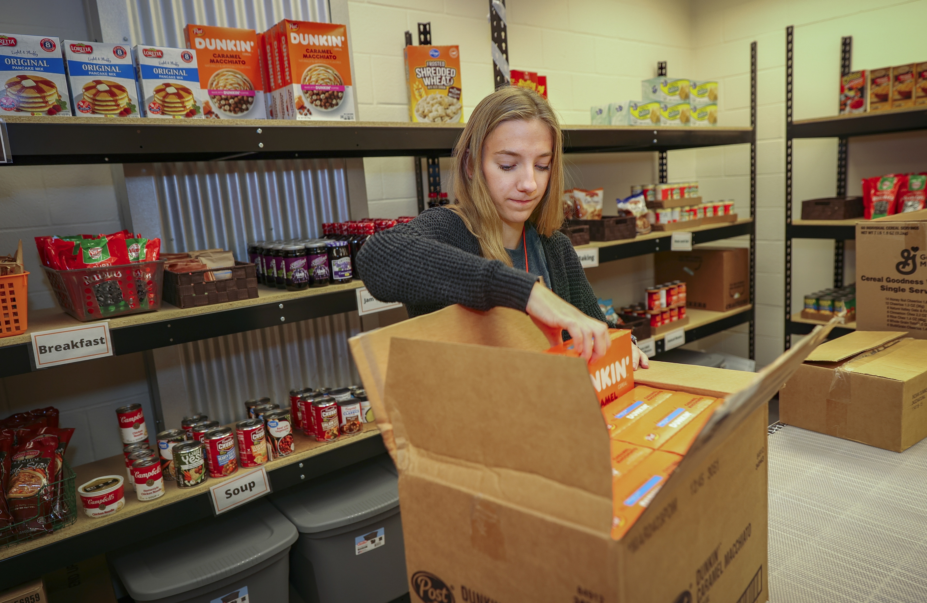 Madelyn Huzyak packing a box full of groceries