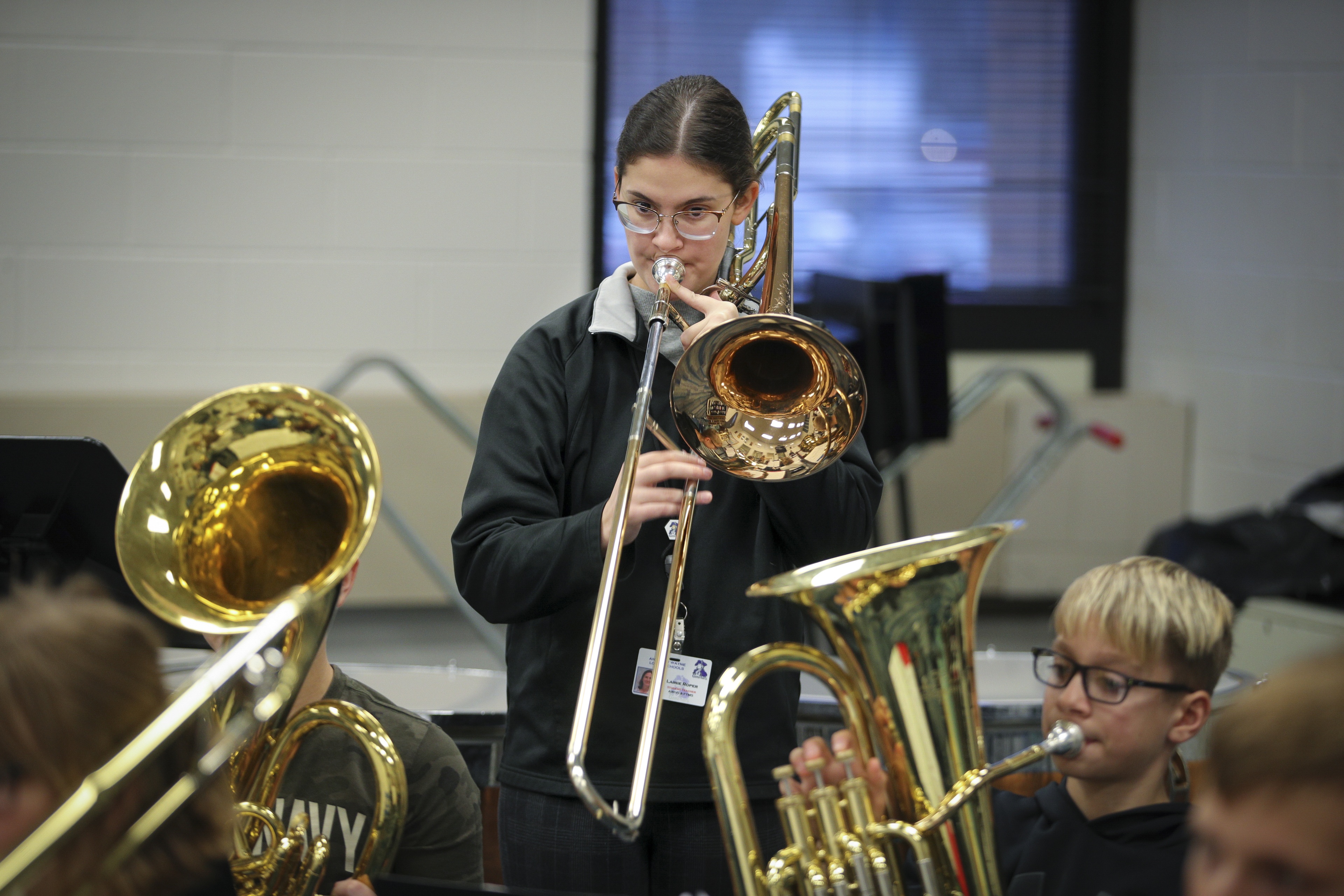 Lainie Roper playing a trombone