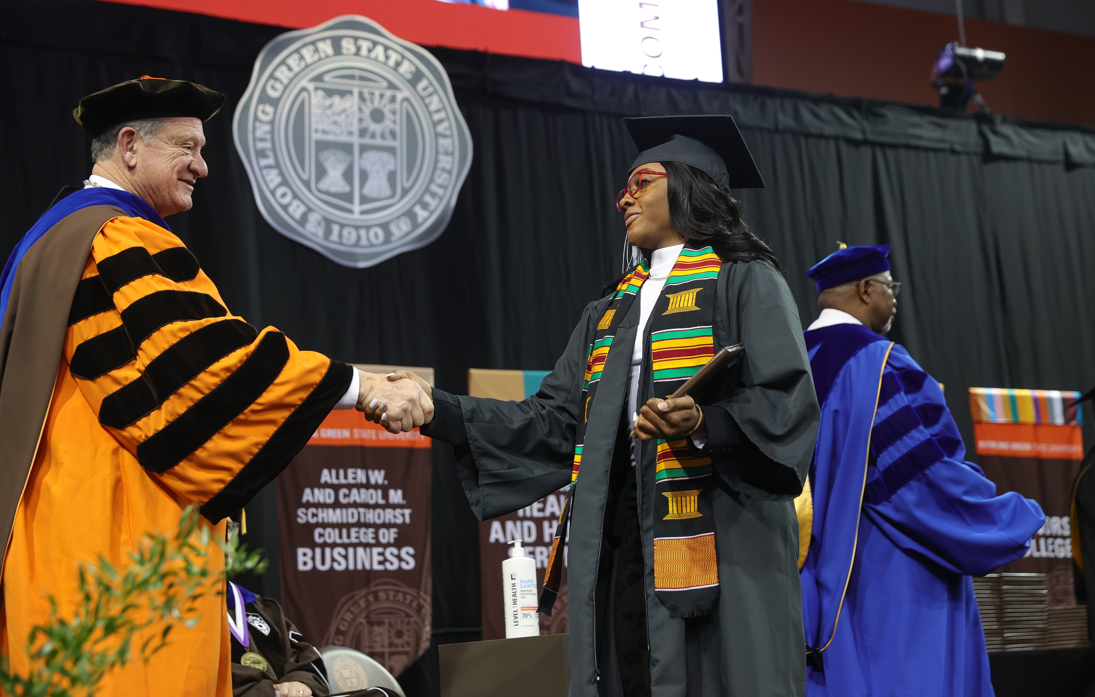 BGSU President Rodney K. Rogers shakes hands with a female graduate