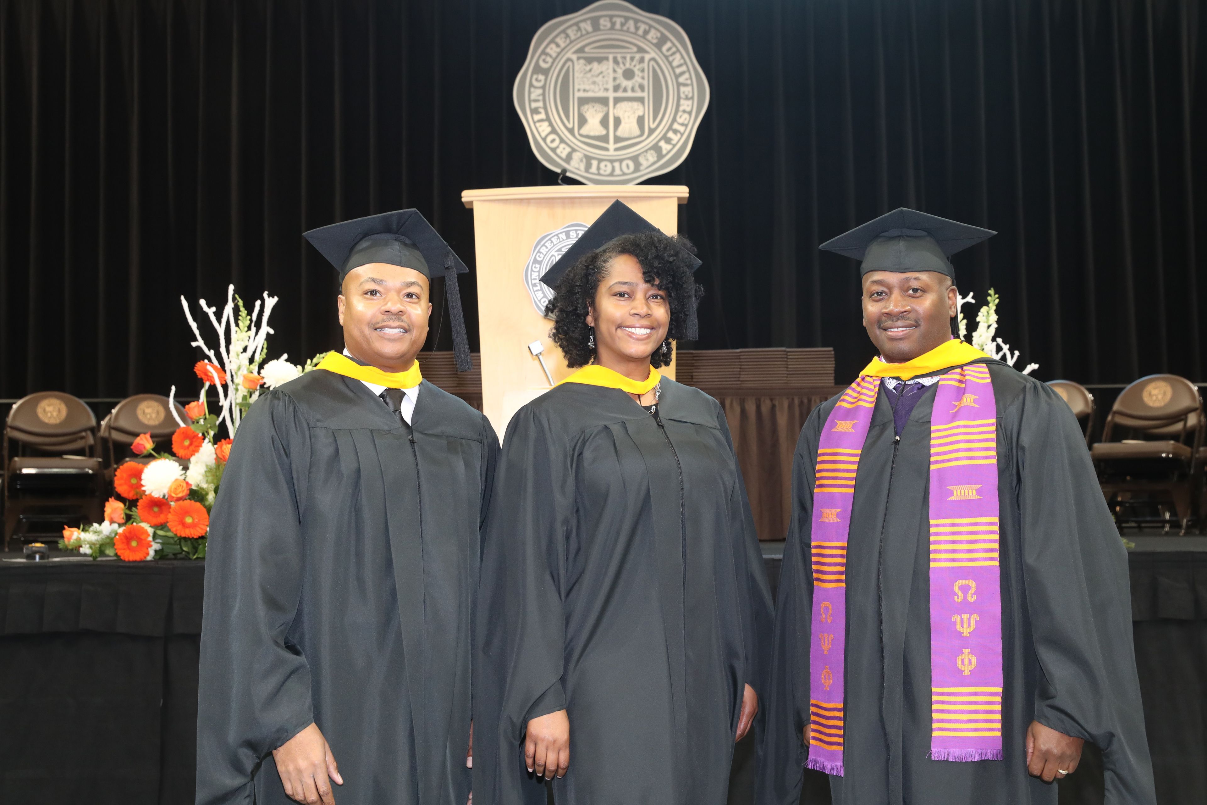 BGSU alumna Elaine Bryant stands between two people on graduation day in 2019