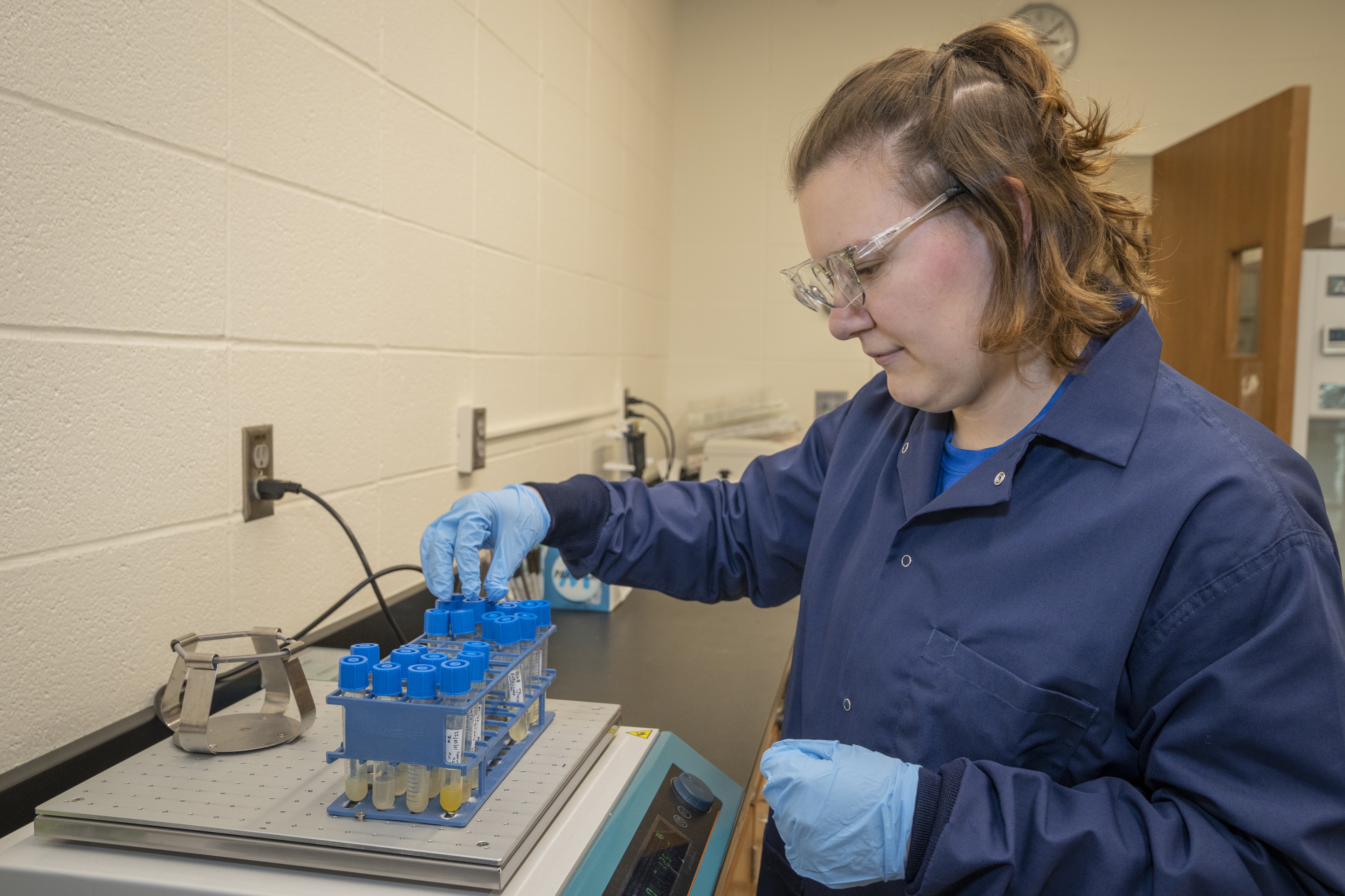 Margaret in the lab gathering a water sample