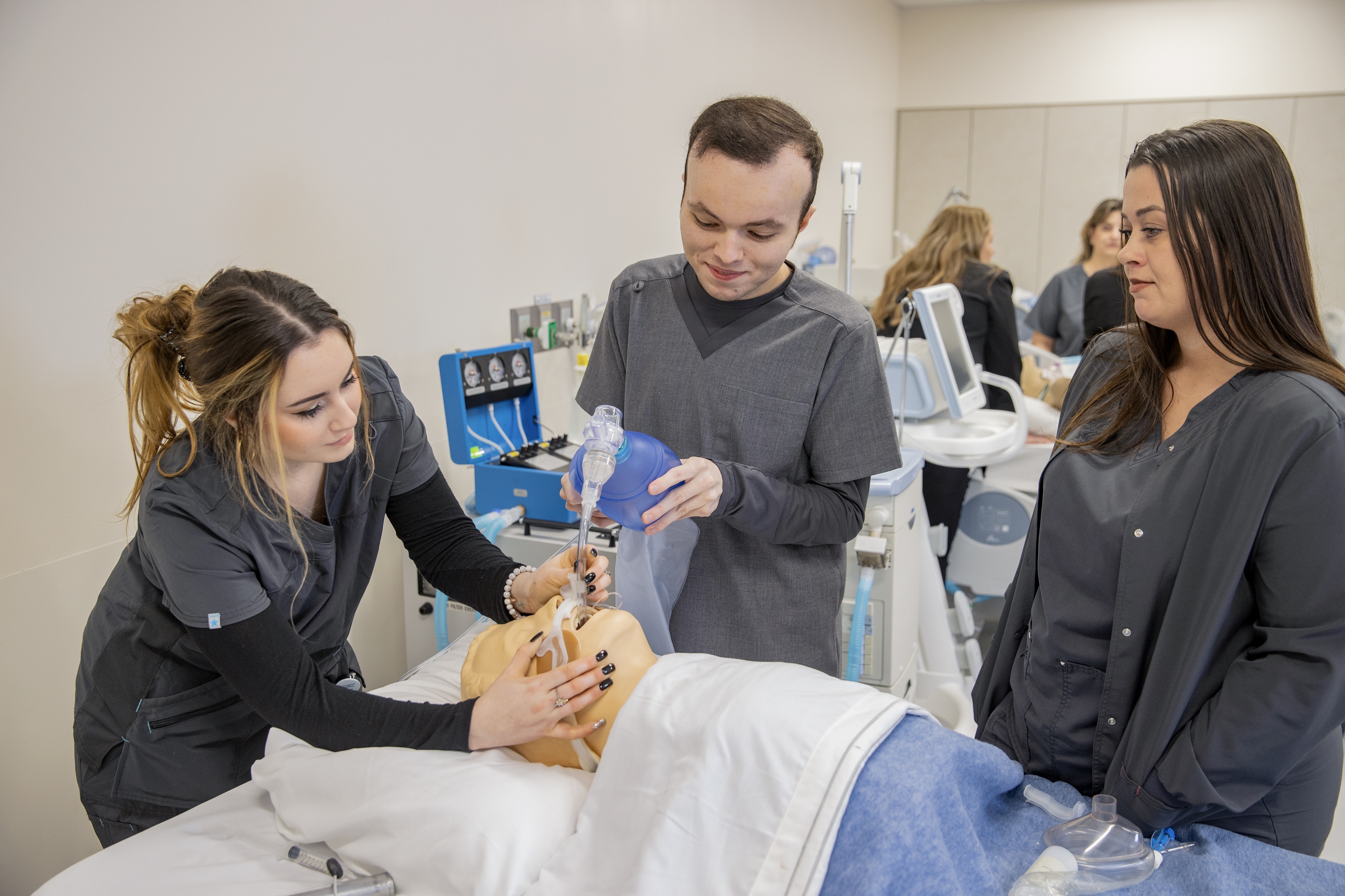Three students work at intubating a medical manikin at the Allied Health Respiratory Care skills lab at BGSU Firelands