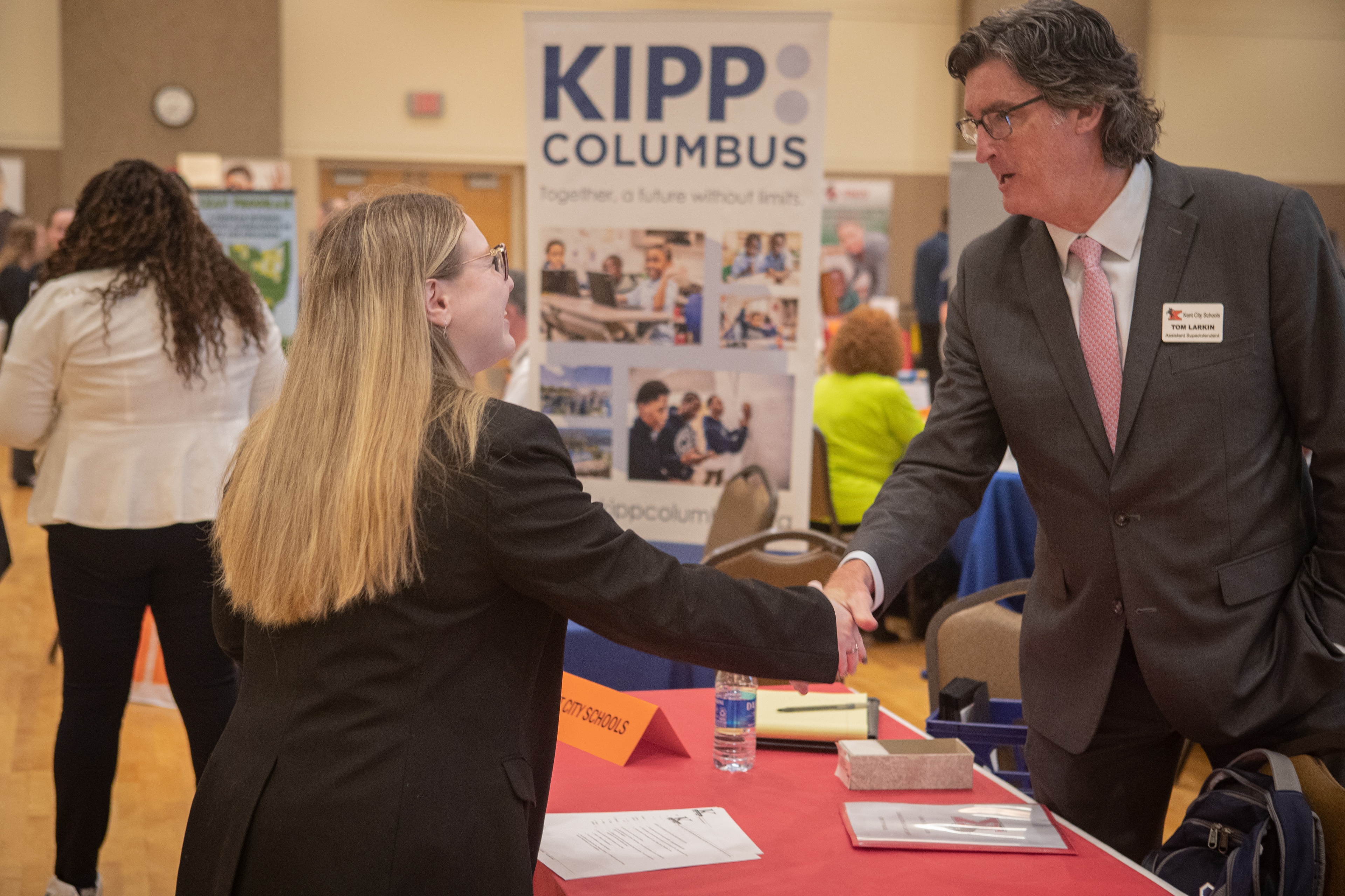 A man and woman shake hands at the BGSU Teacher Job Fair 