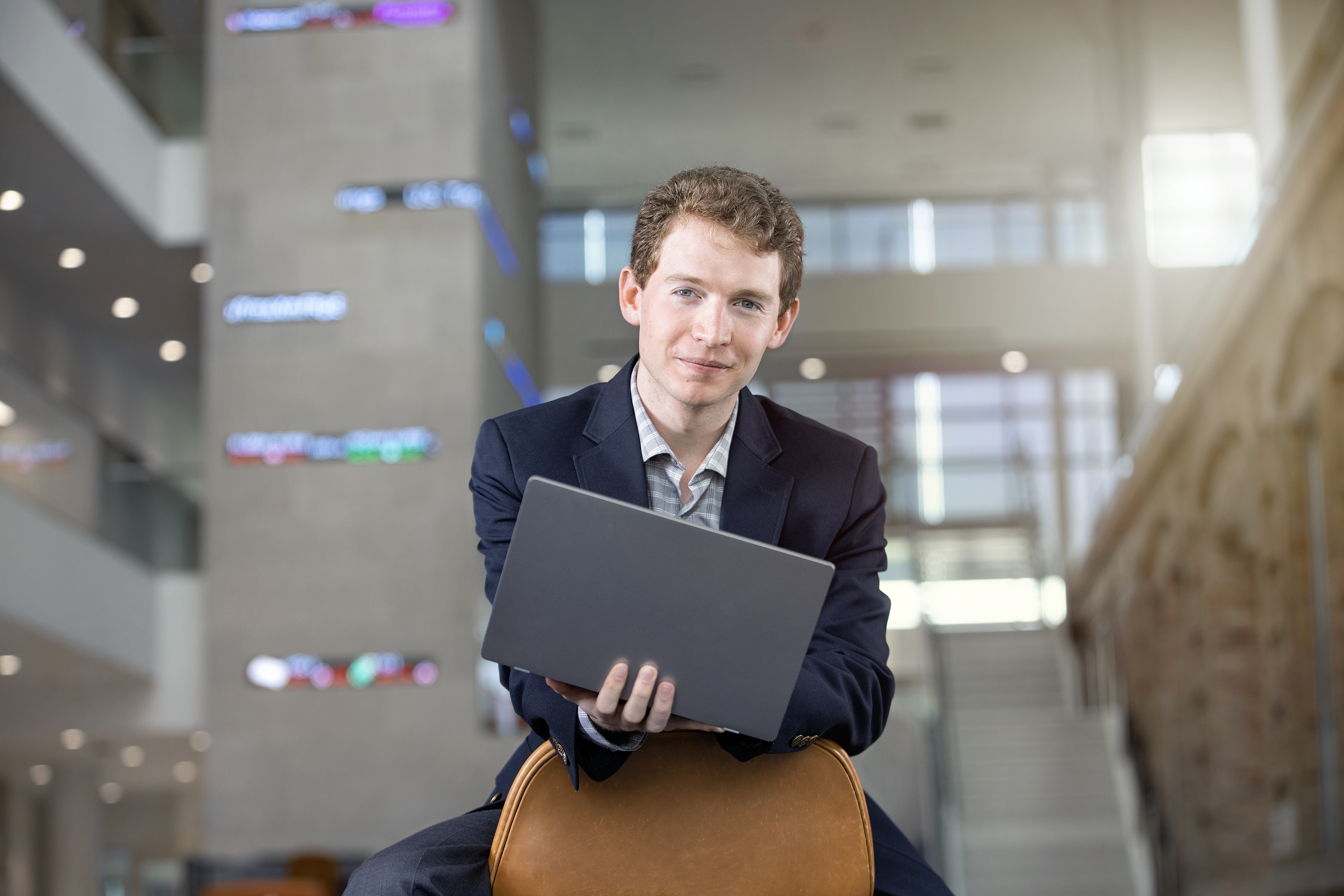 Matt DeAmon holds a laptop computer.