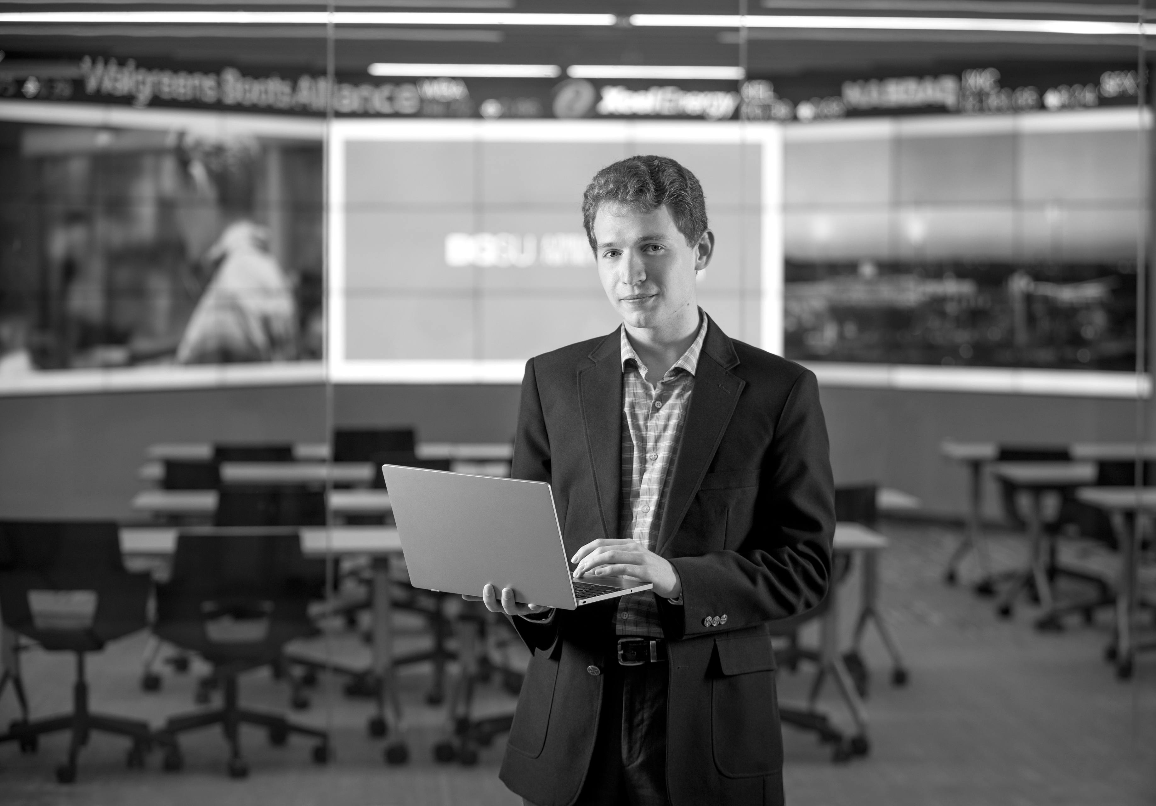 Matt DeAmon holds a laptop computer.