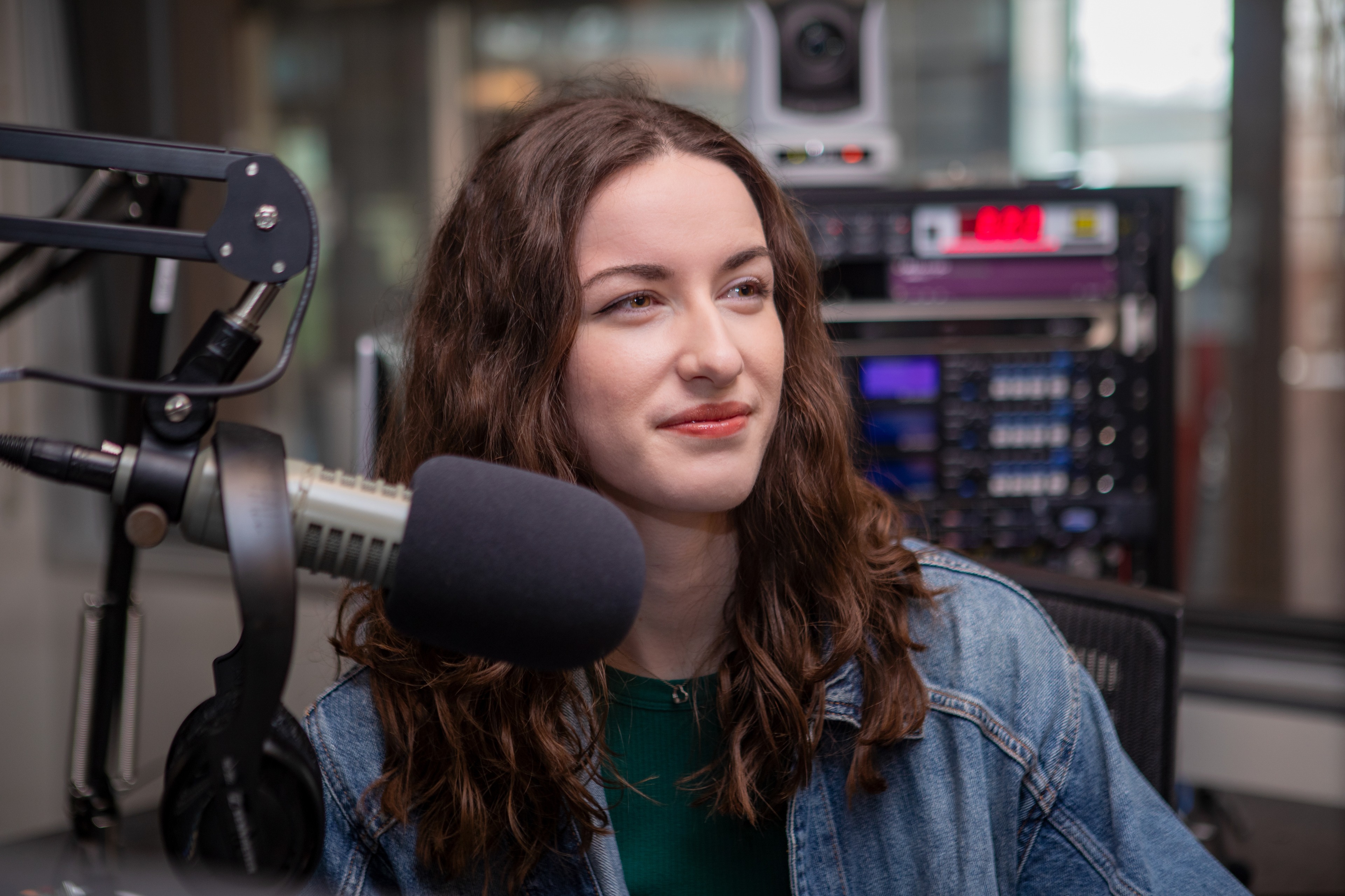 Taylor Kitchen sits in front of a microphone