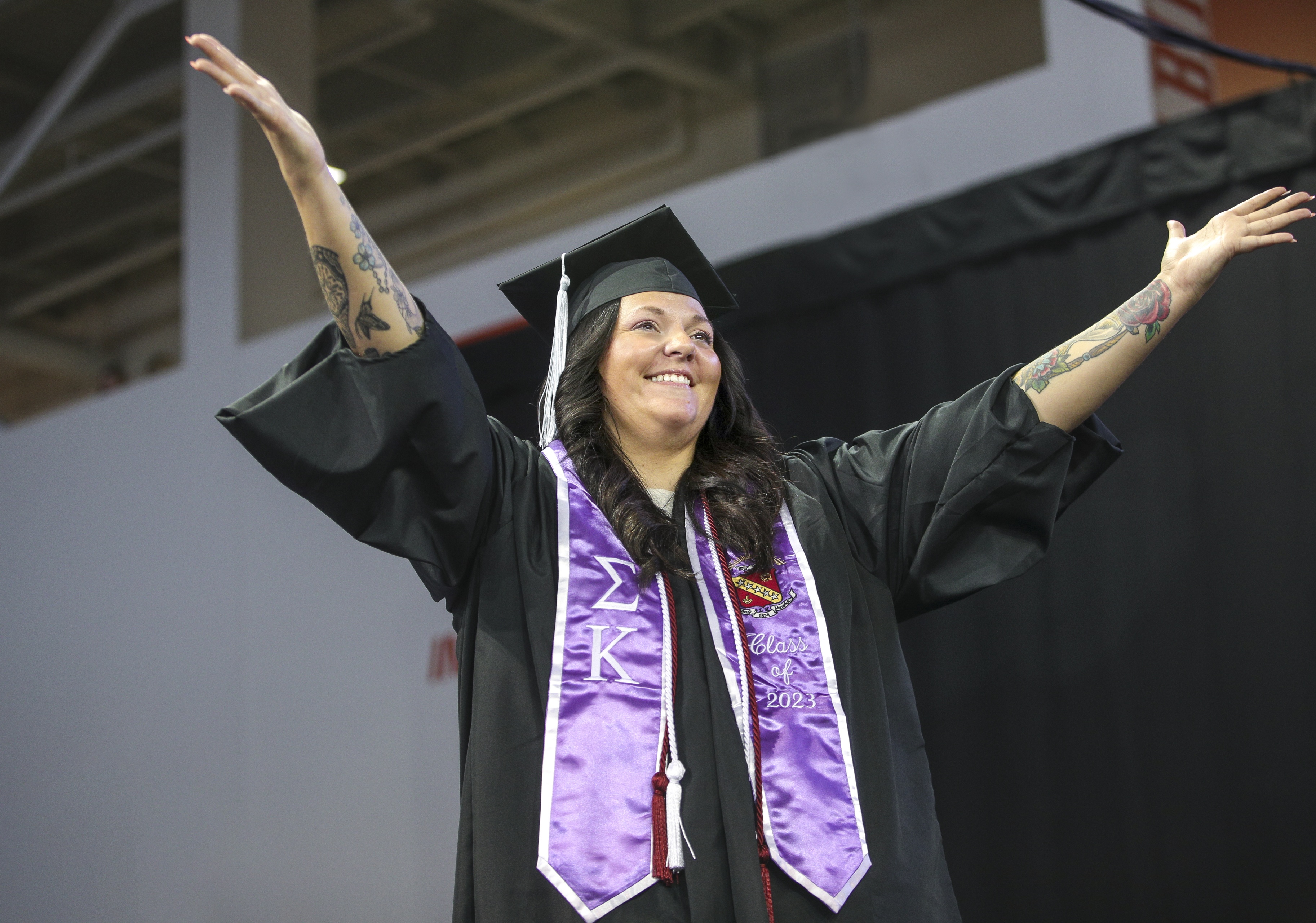 gradute celebrating with hands raised