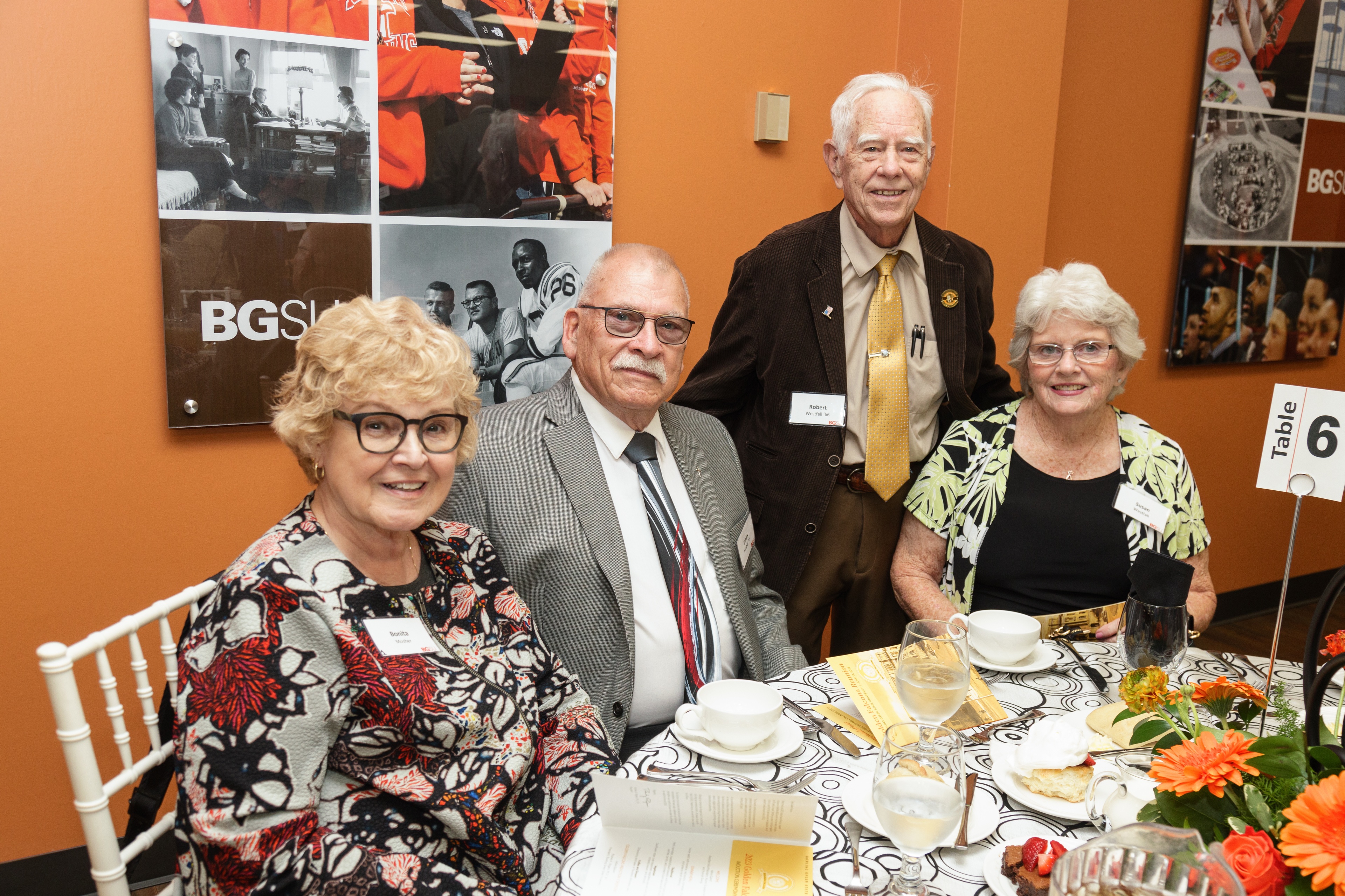 Two couples sit at a table during the Golden Falcons reunion