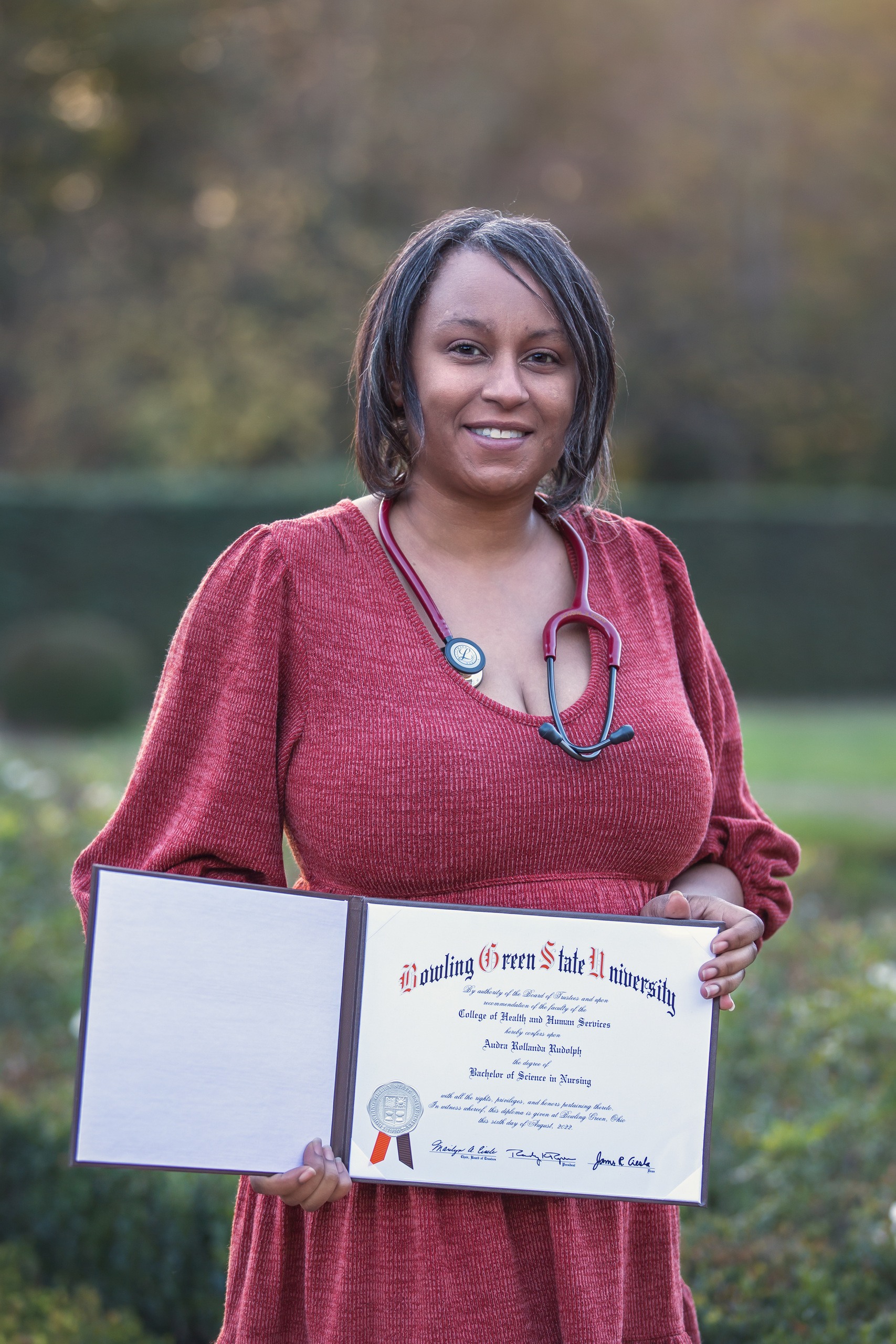 Woman poses with degree