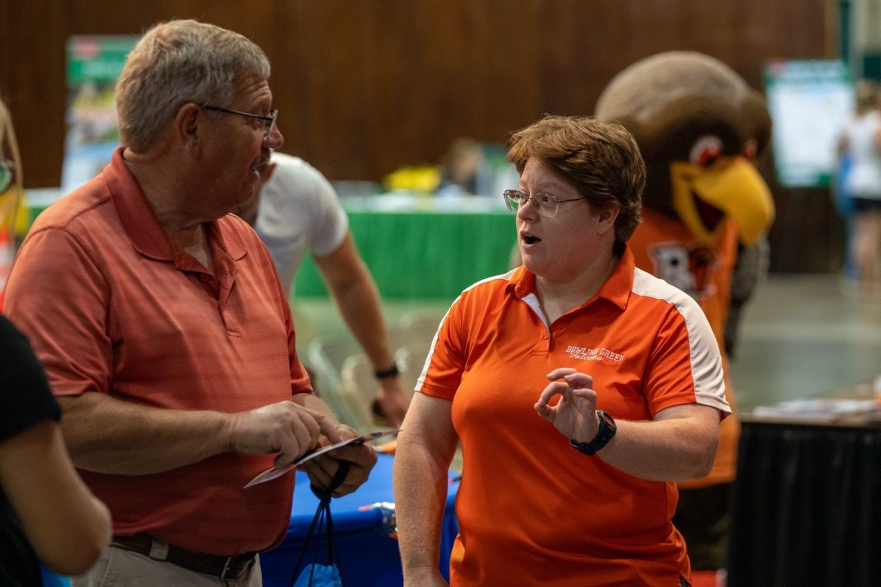 Dr. Kate Dellenbusch talks about the total solar eclipse with a fairgoer