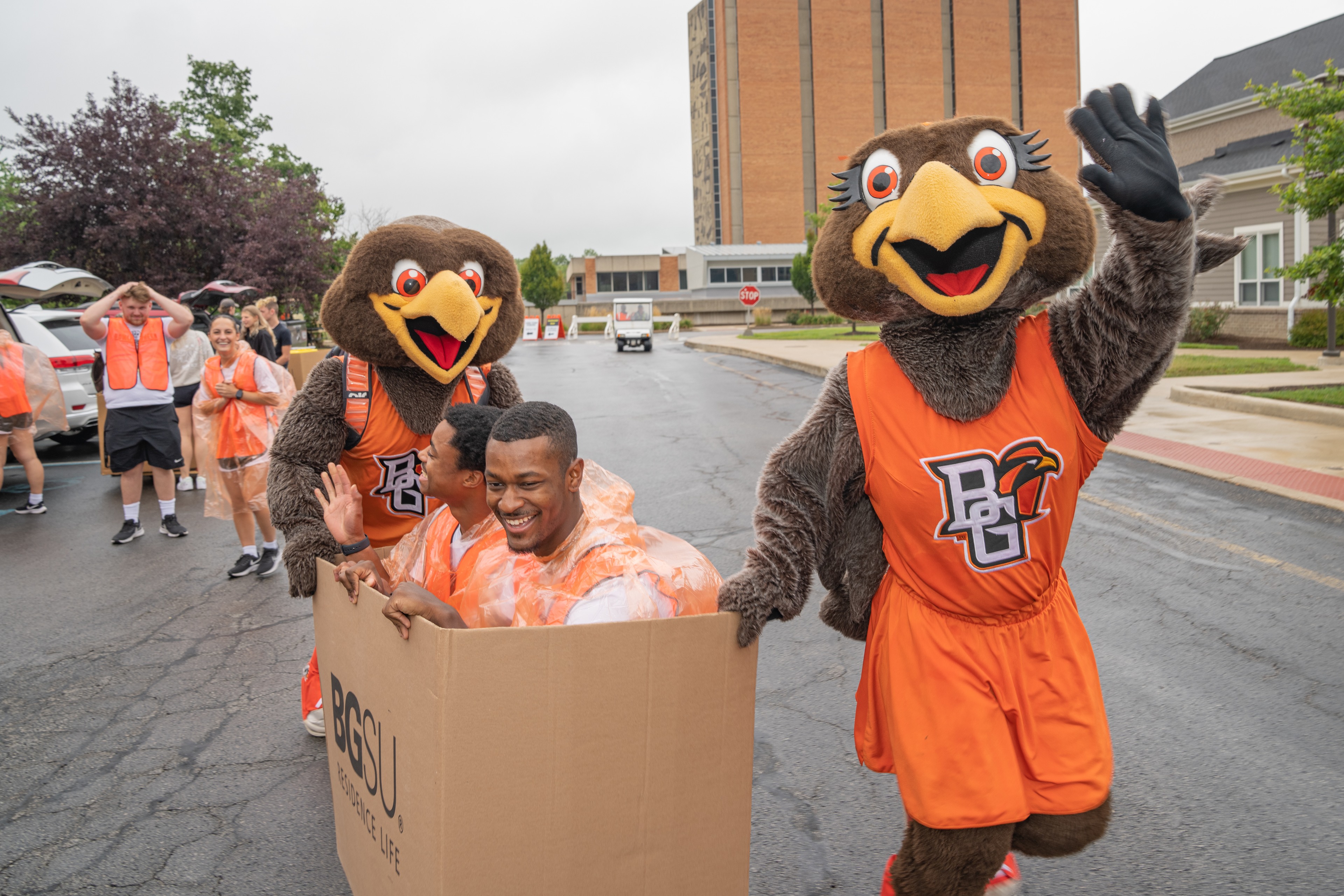 Student move-in volunteers enjoy a free ride from mascots Freddie and Frieda as they helped incoming freshman move into their residence halls. 