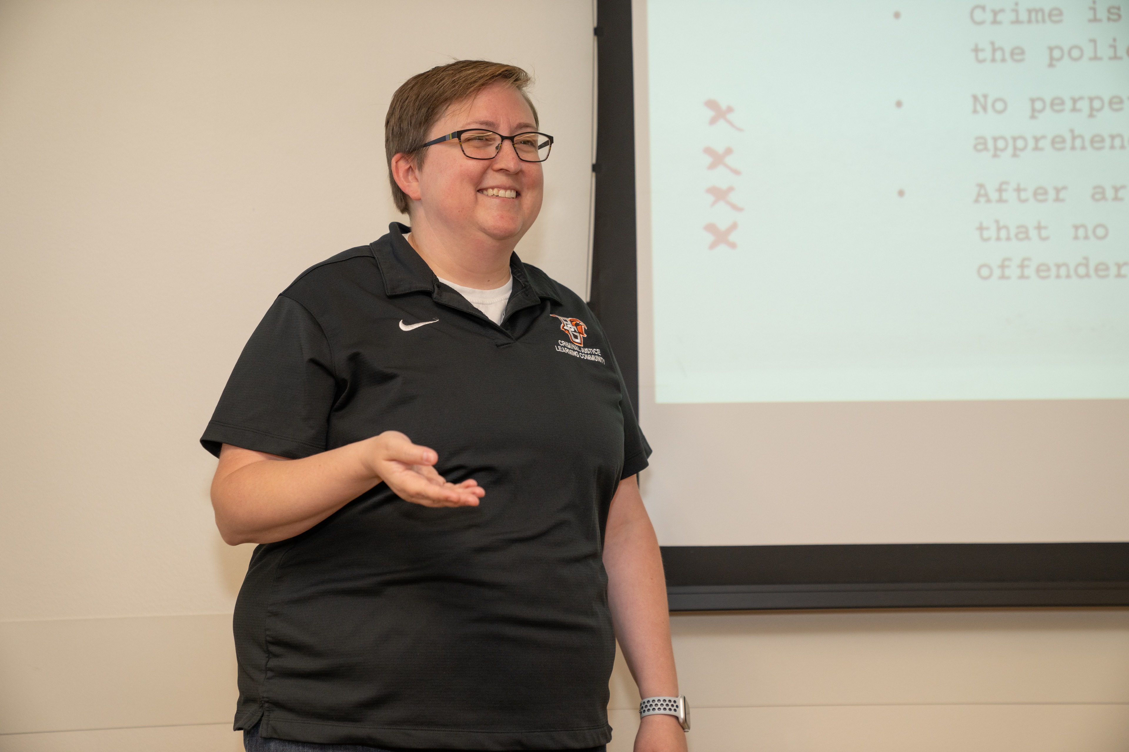 Catherine Pape smiles while teaching in a classroom.