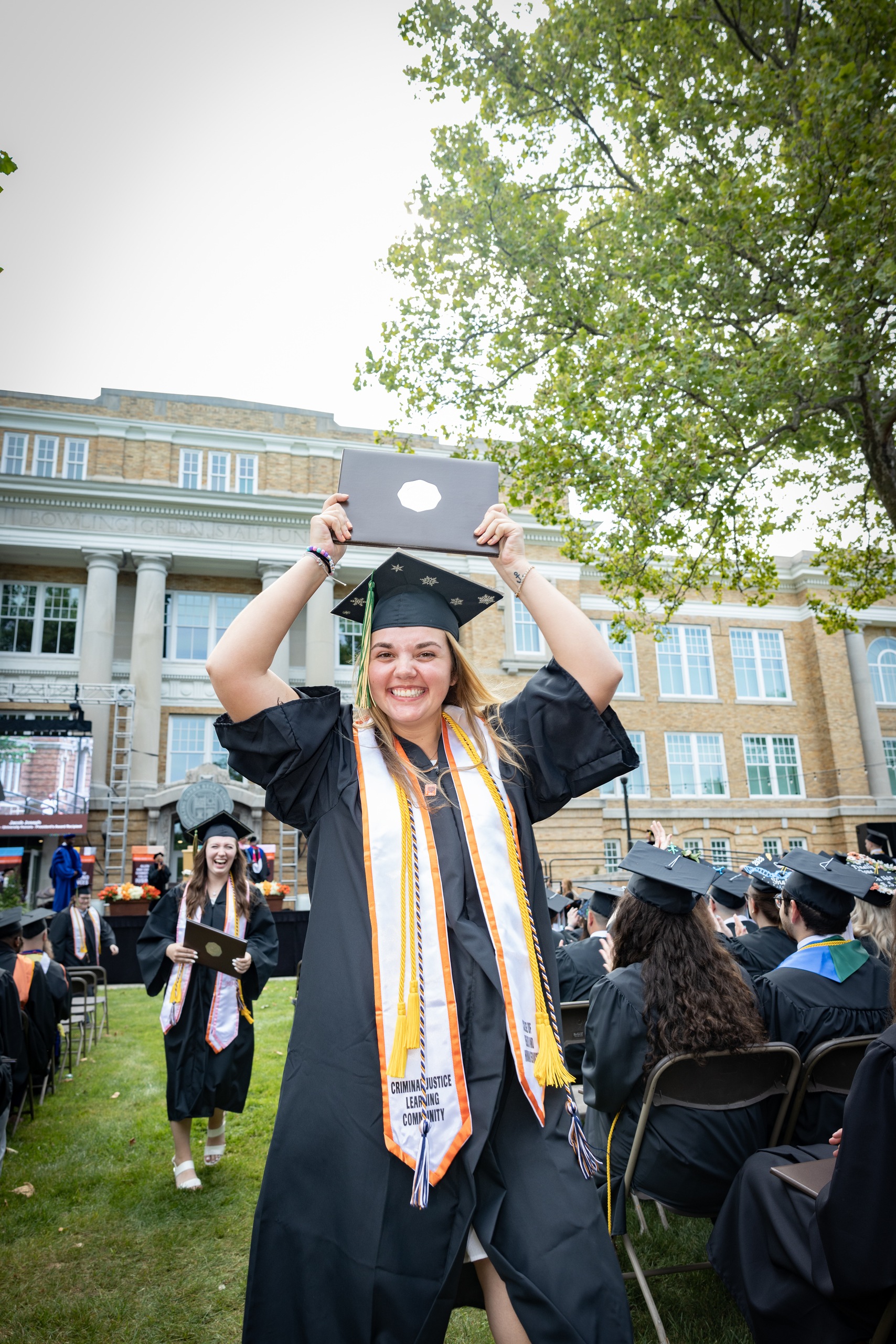 Karlee Augustus holds up her degree. 