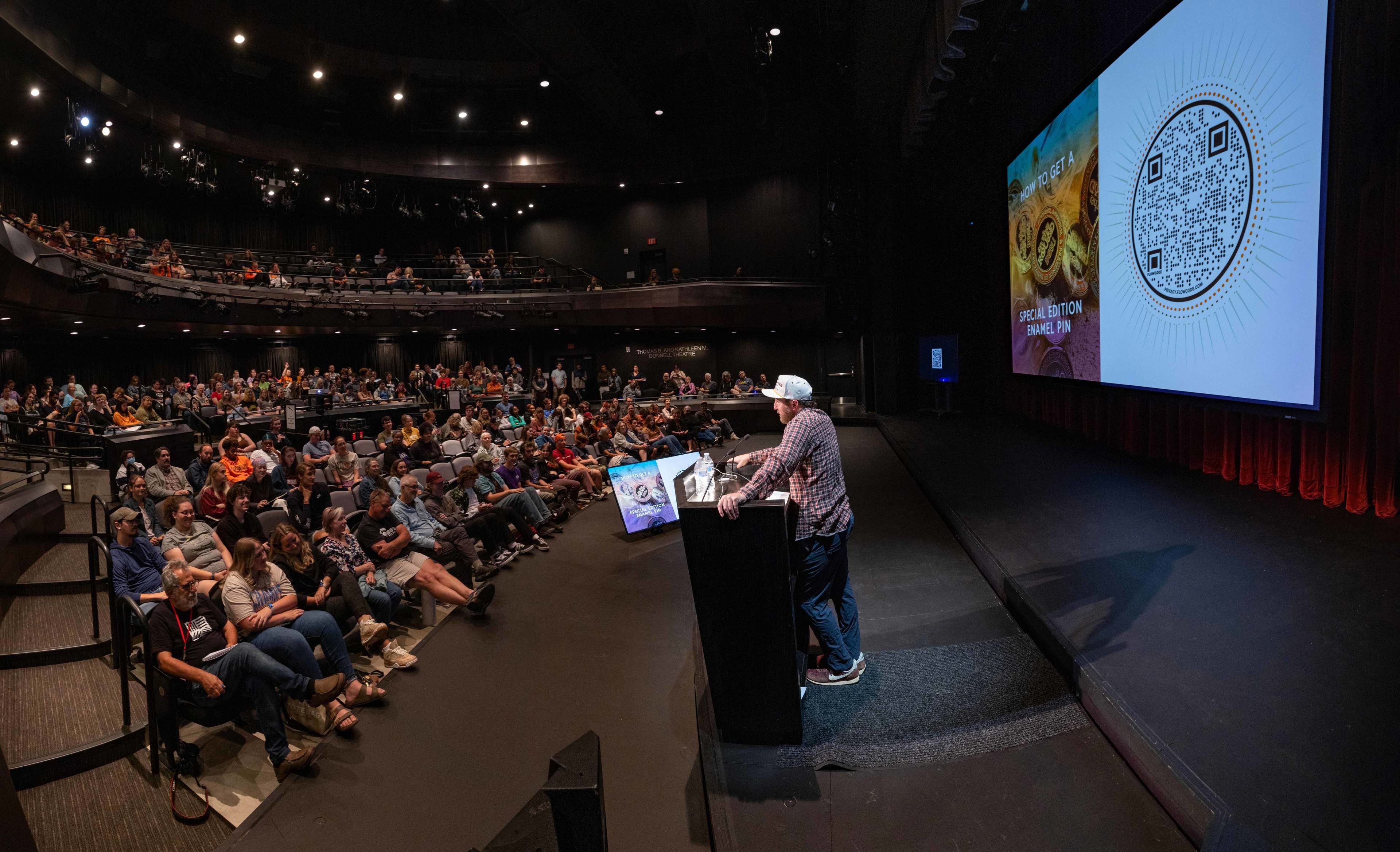 Ryan RedCorn speaks before a large crowd at the Donnell Theatre.