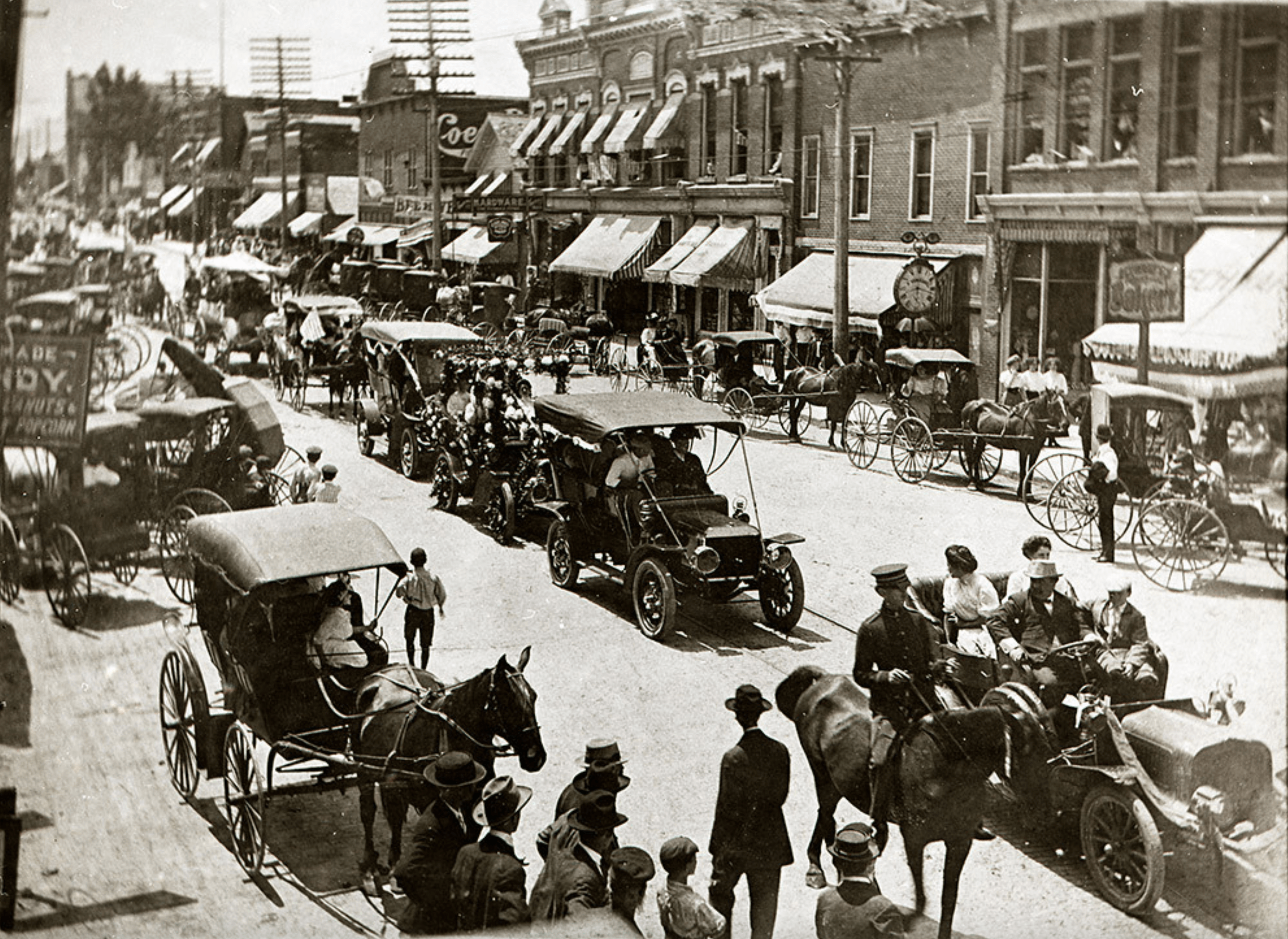 Cars and carriages are seen on Main Street in Bowling Green during a parade circa 1910. 