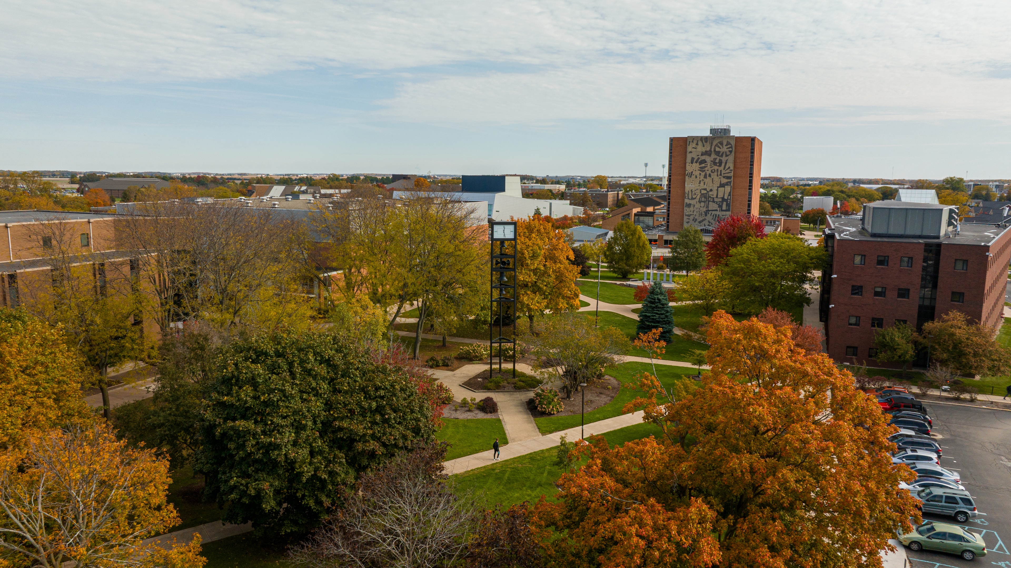 Jerome Library is pictured in the distance of a photo taken by drone showing campus trees changing color
