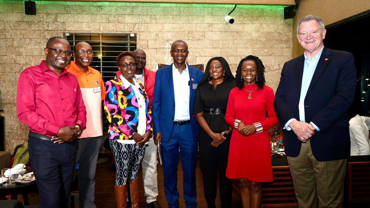 A group of Kenyan BGSU alumni pose for a photograph with BGSU President Rodney K. Rogers in May 2023.