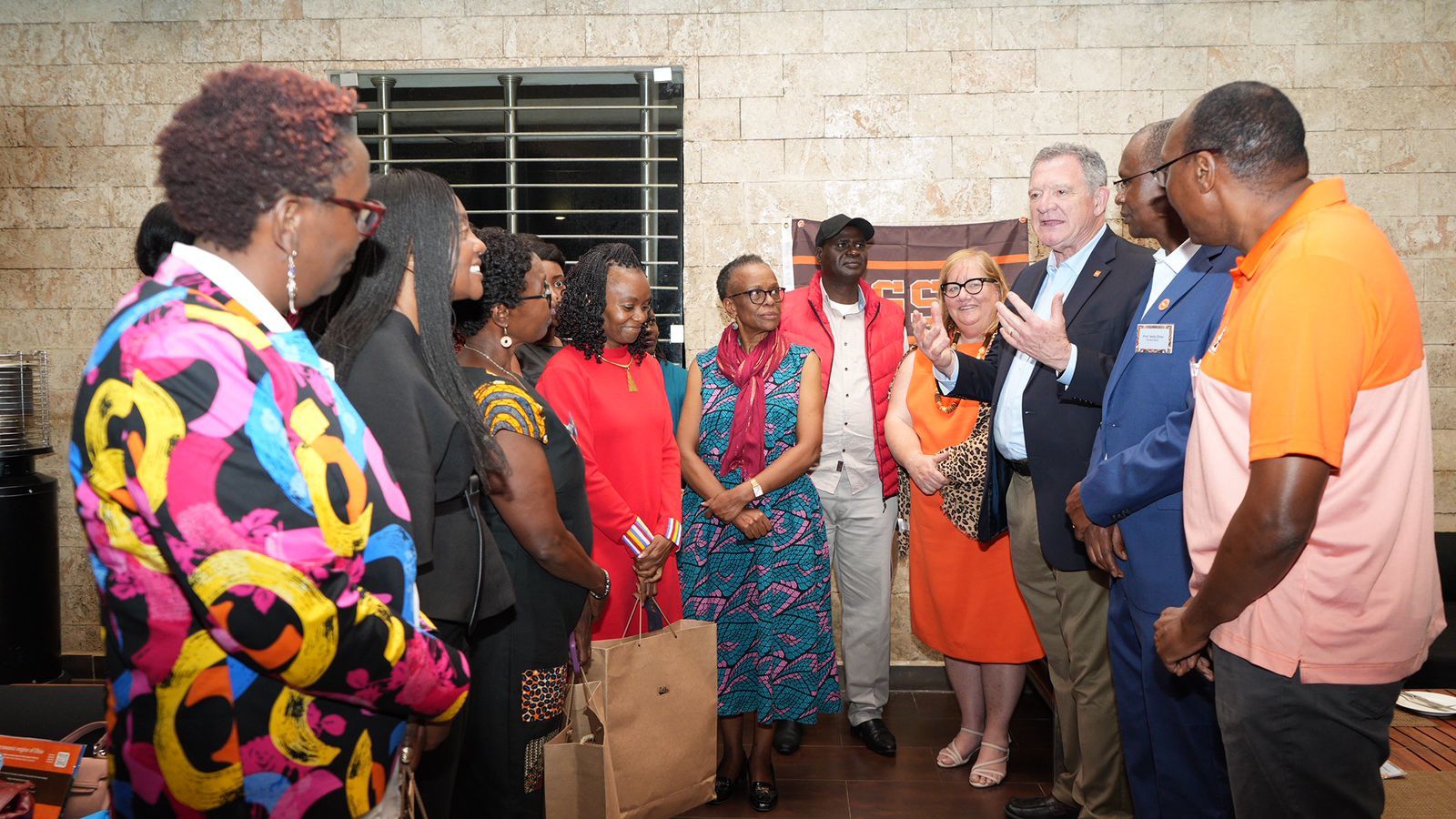 A group of Kenyan BGSU alumni pose for a photograph with BGSU President Rodney K. Rogers in May 2023.