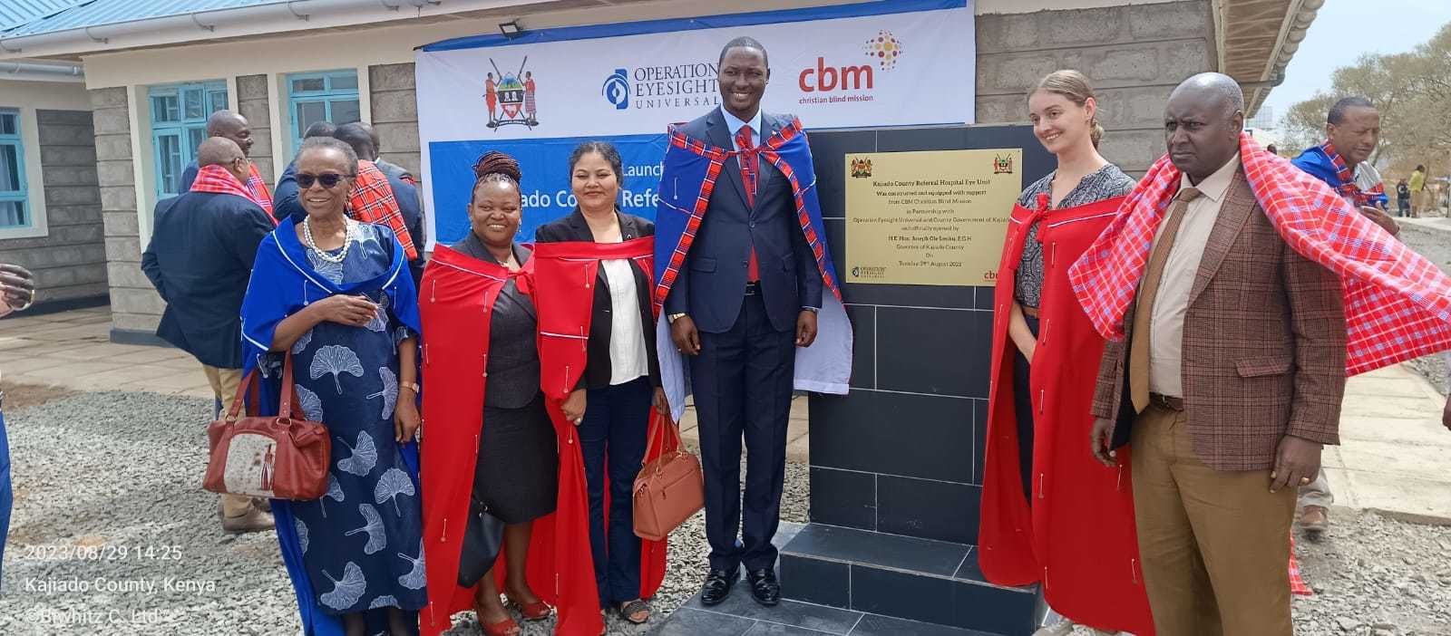 A group poses outside of an eye unit in Kenya during its official opening.