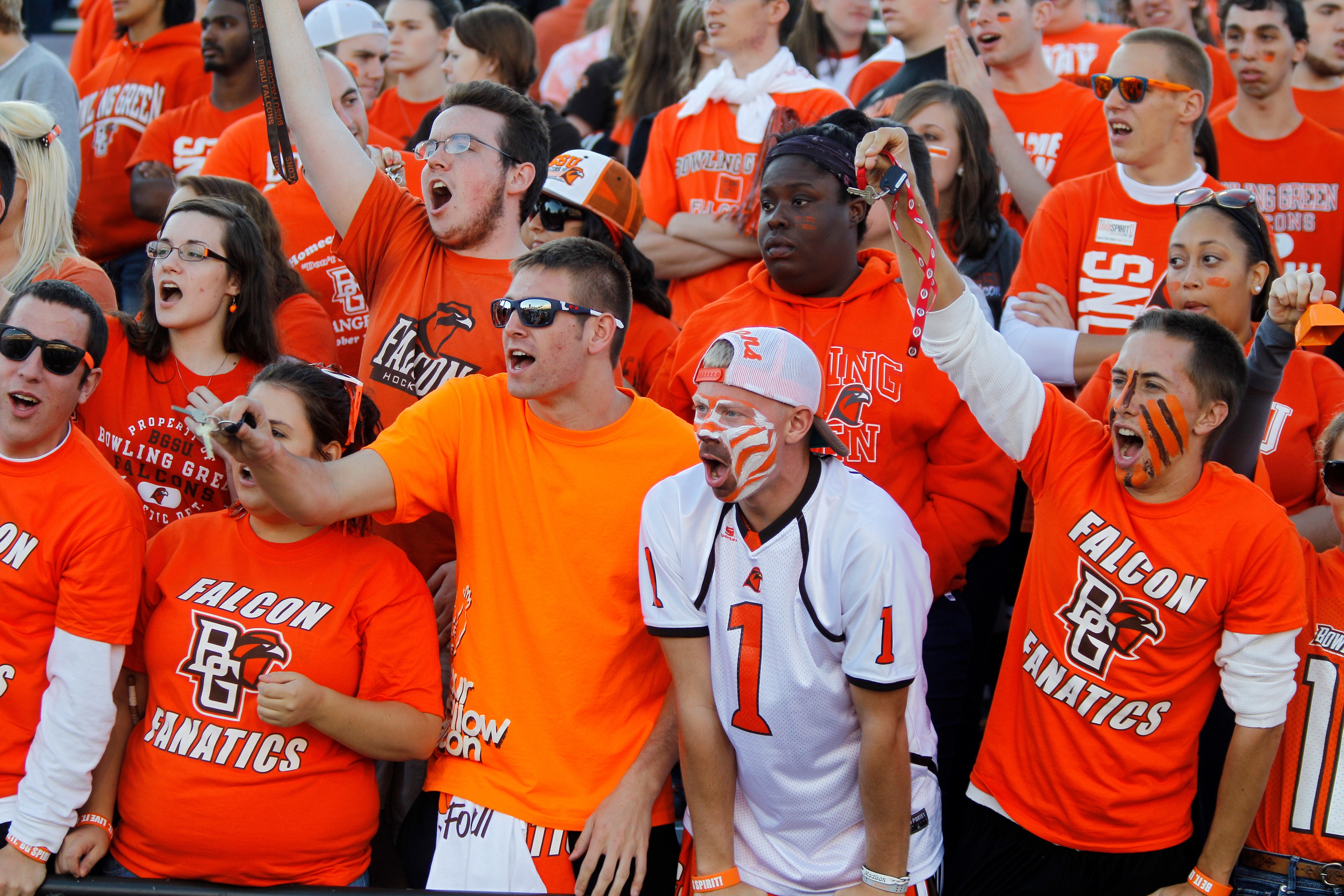 BGSU fans cheer a football game wearing shirts that say Falcon Fanatics 