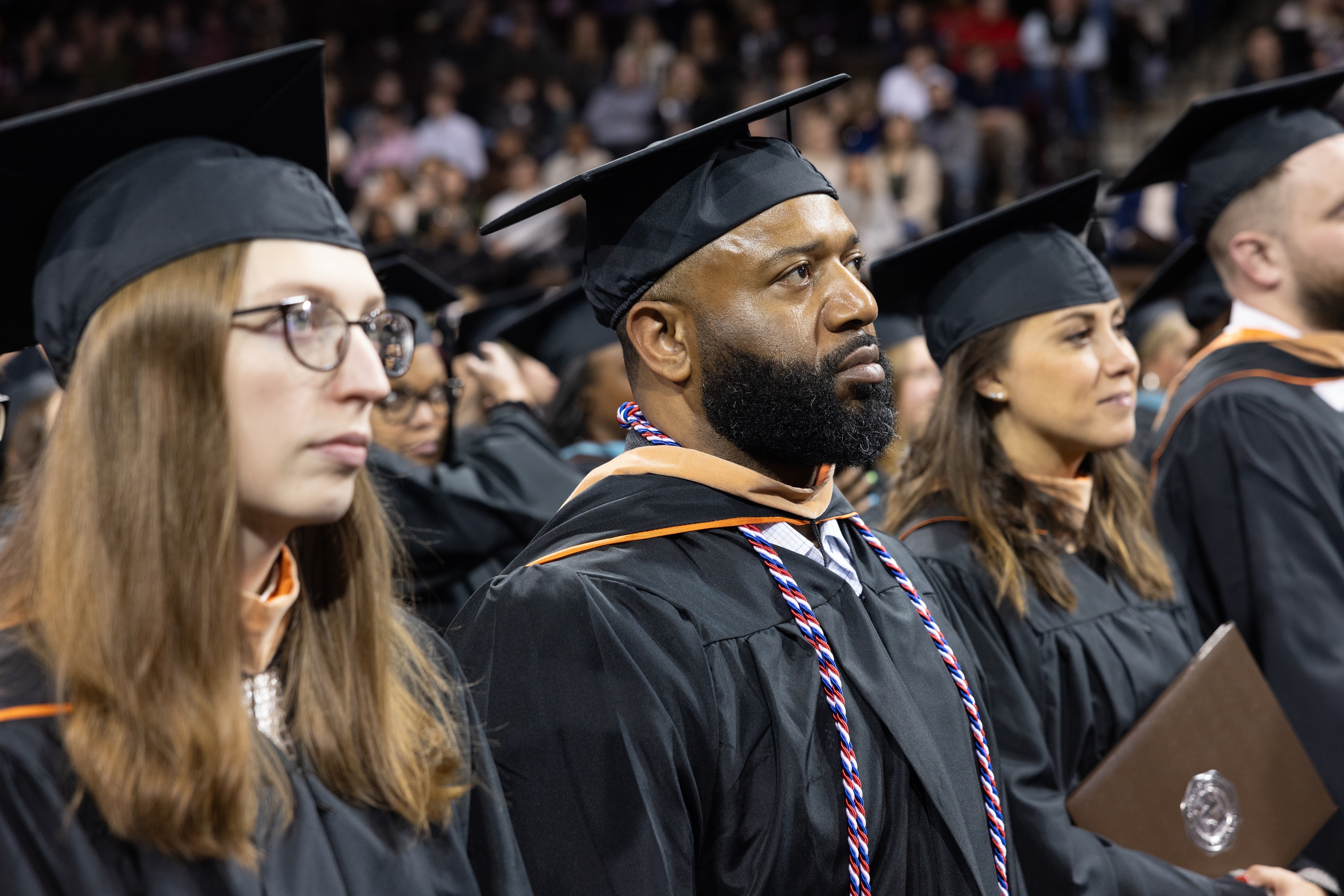 BGSU graduates standing at commencement