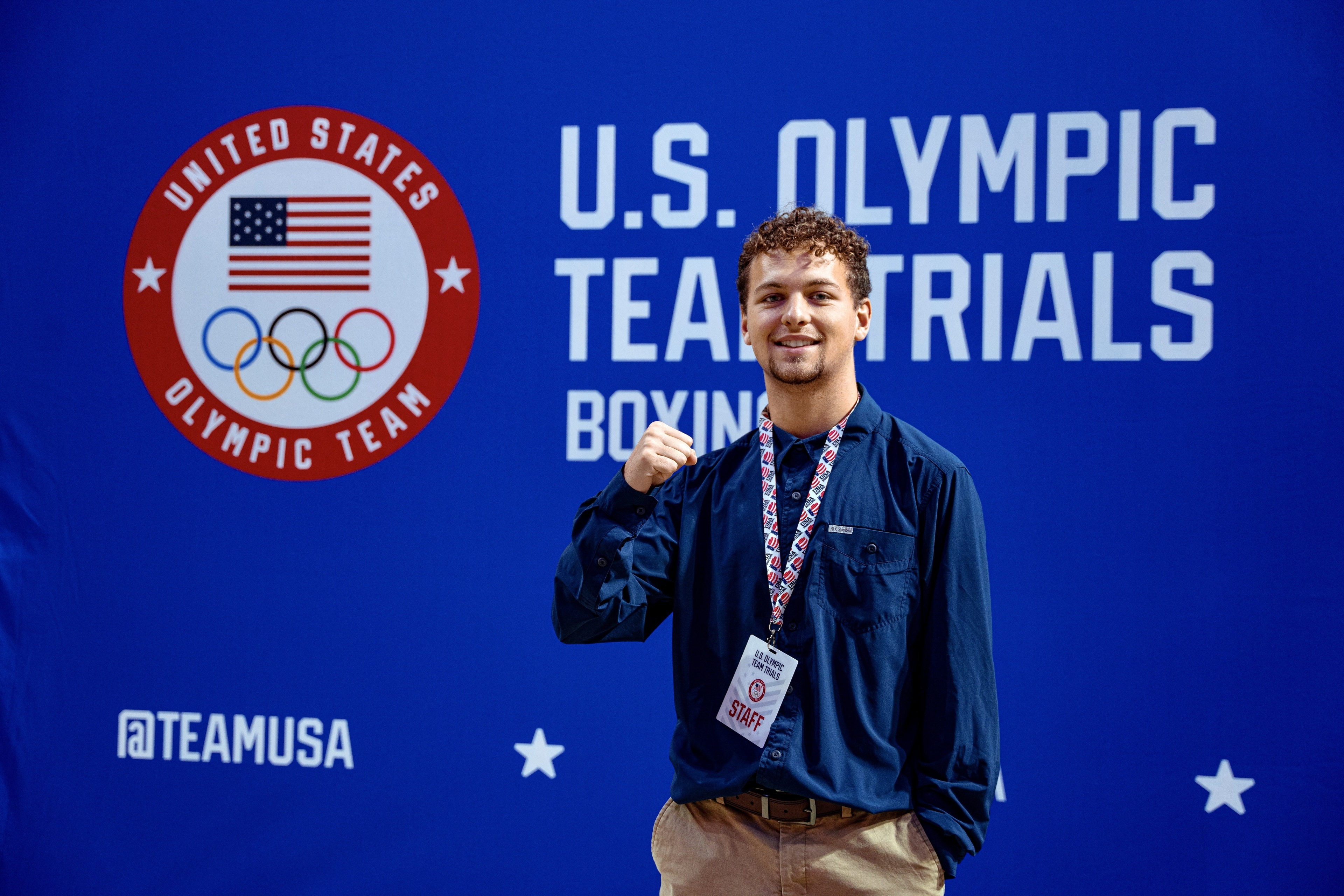 Nathan Kubala stands in front of a large blue background that reads "U.S. Olympic Team Trials."