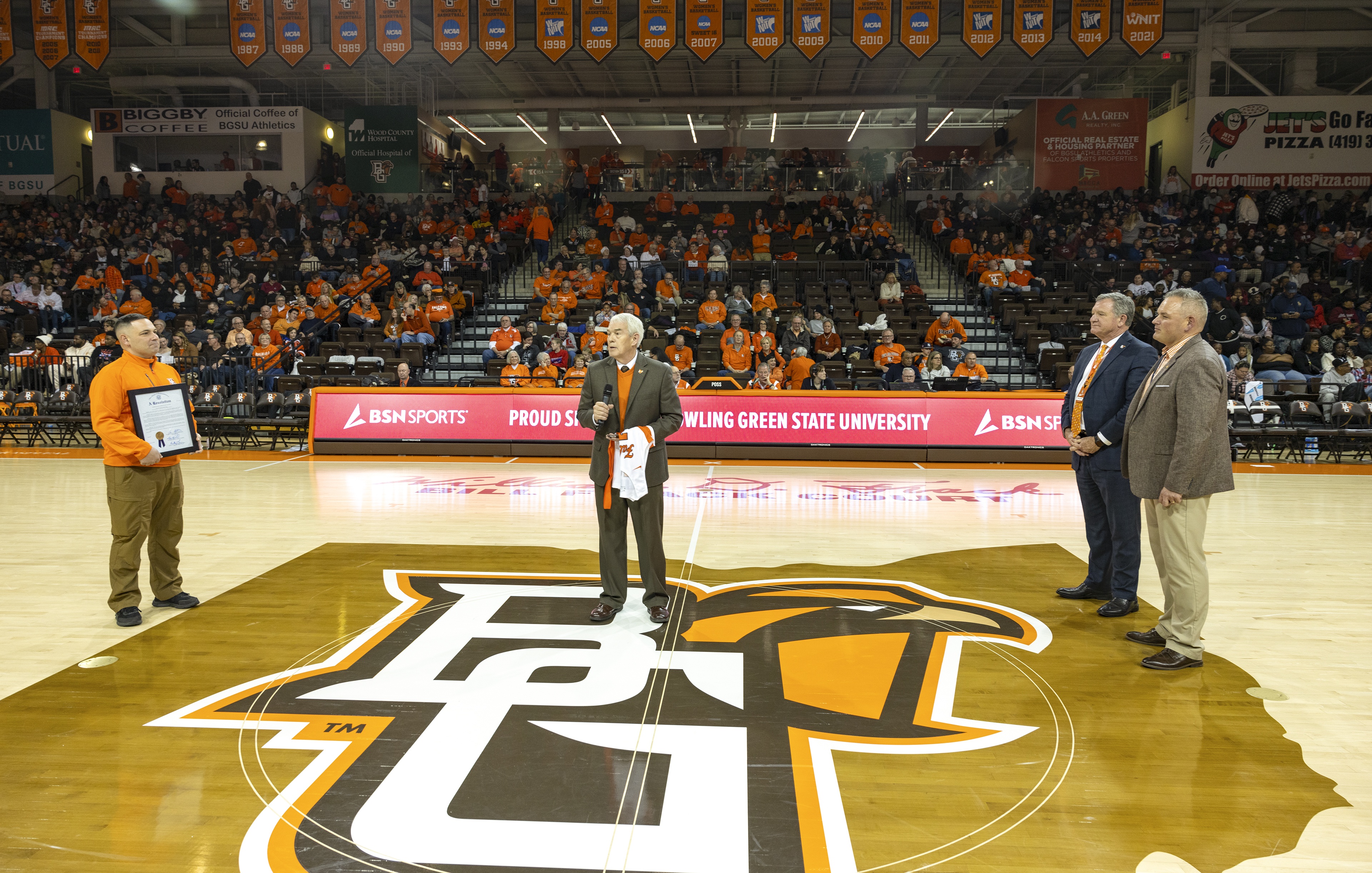 Ohio Rep. Haraz Ghanbari, Chancellor Randy Gardner, BGSU President Rodney K. Rogers and BGSU Director of Athletics Derek van der Merwe stand on the court at the Stroh Center.