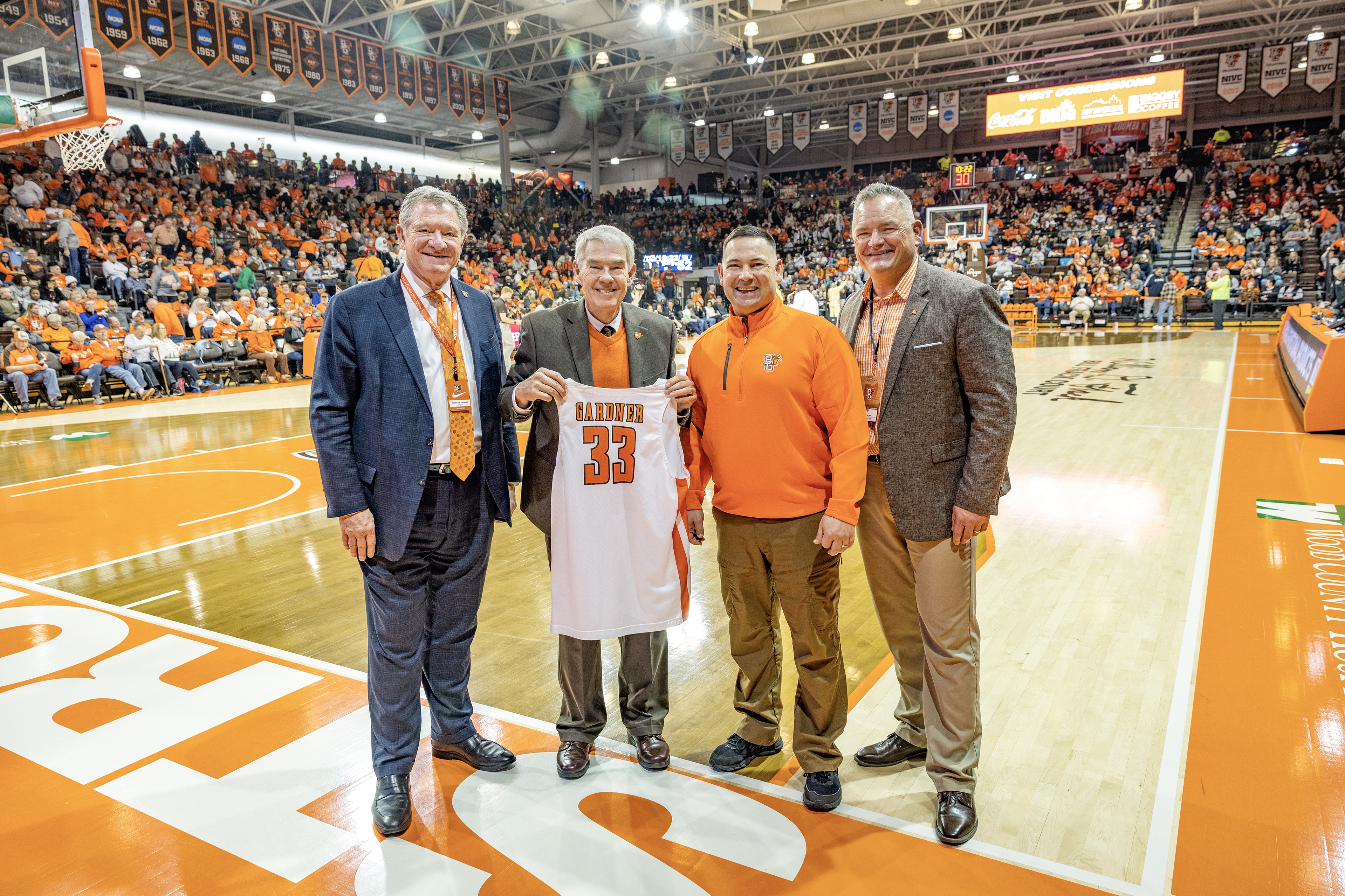 BGSU President Rodney K. Rogers, Ohio Department of Higher Education Chancellor Randy Gardner, Ohio Rep. Haraz Ghanbari and BGSU Athletic Director Derek van der Merwe stand on the court at the Stroh Center. 