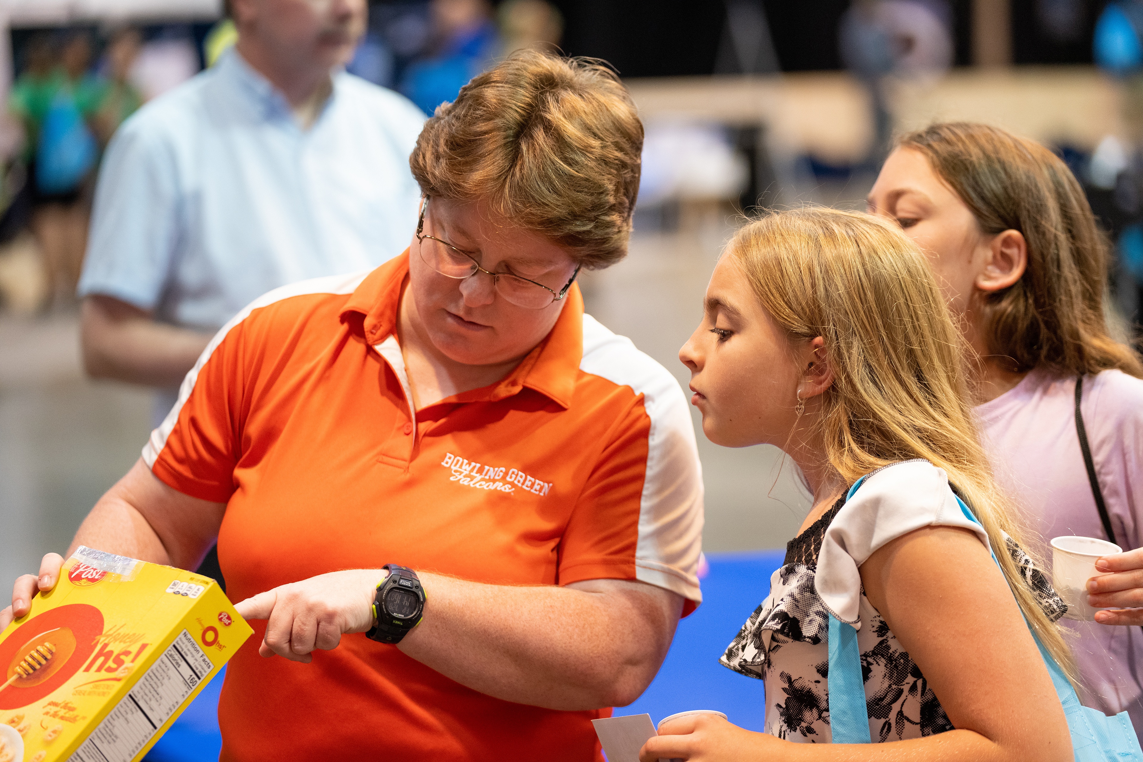 A BGSU professor teaching people at the Ohio State Fair how a cereal box can be used to safely view the solar eclipse. 