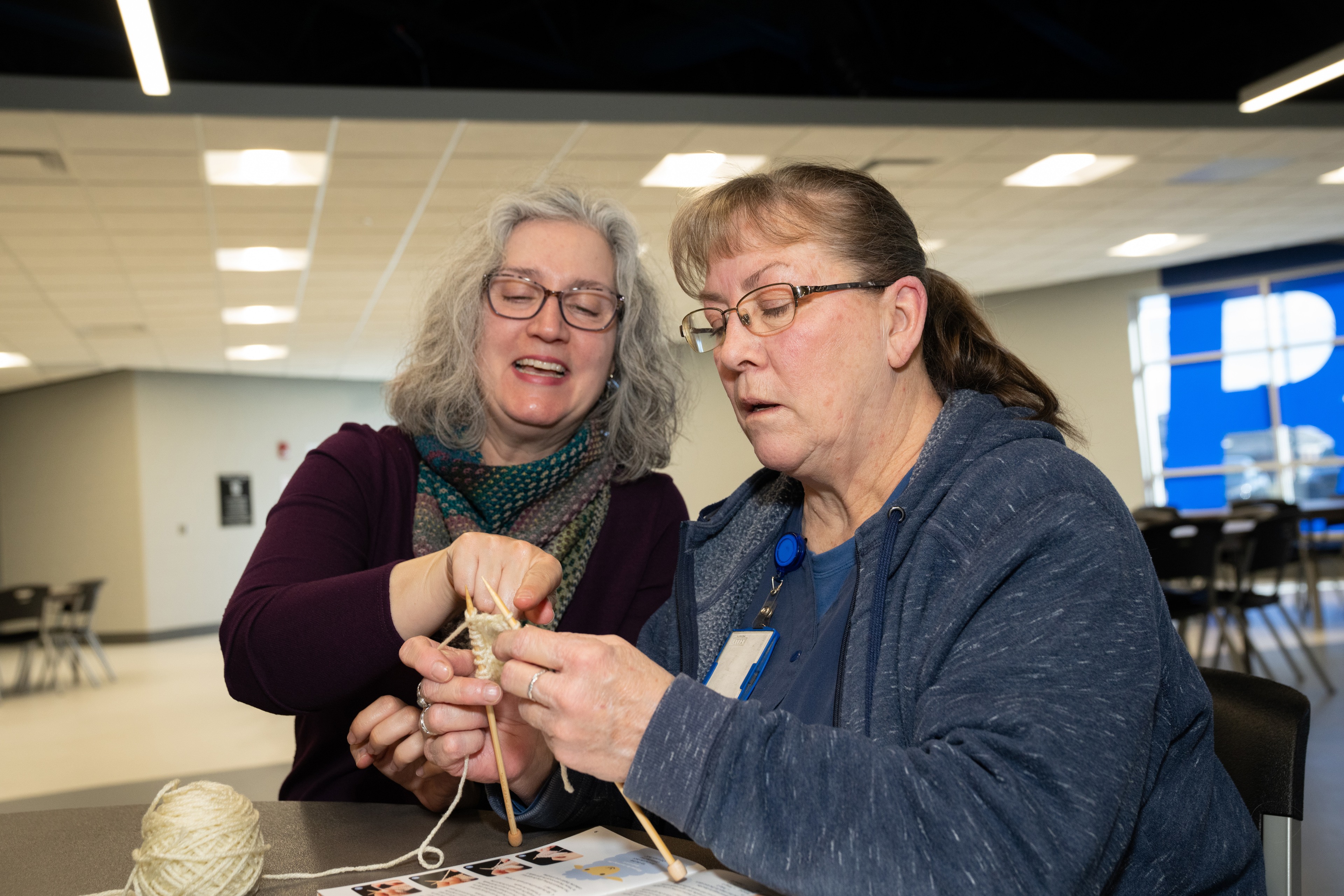 Two people knitting together