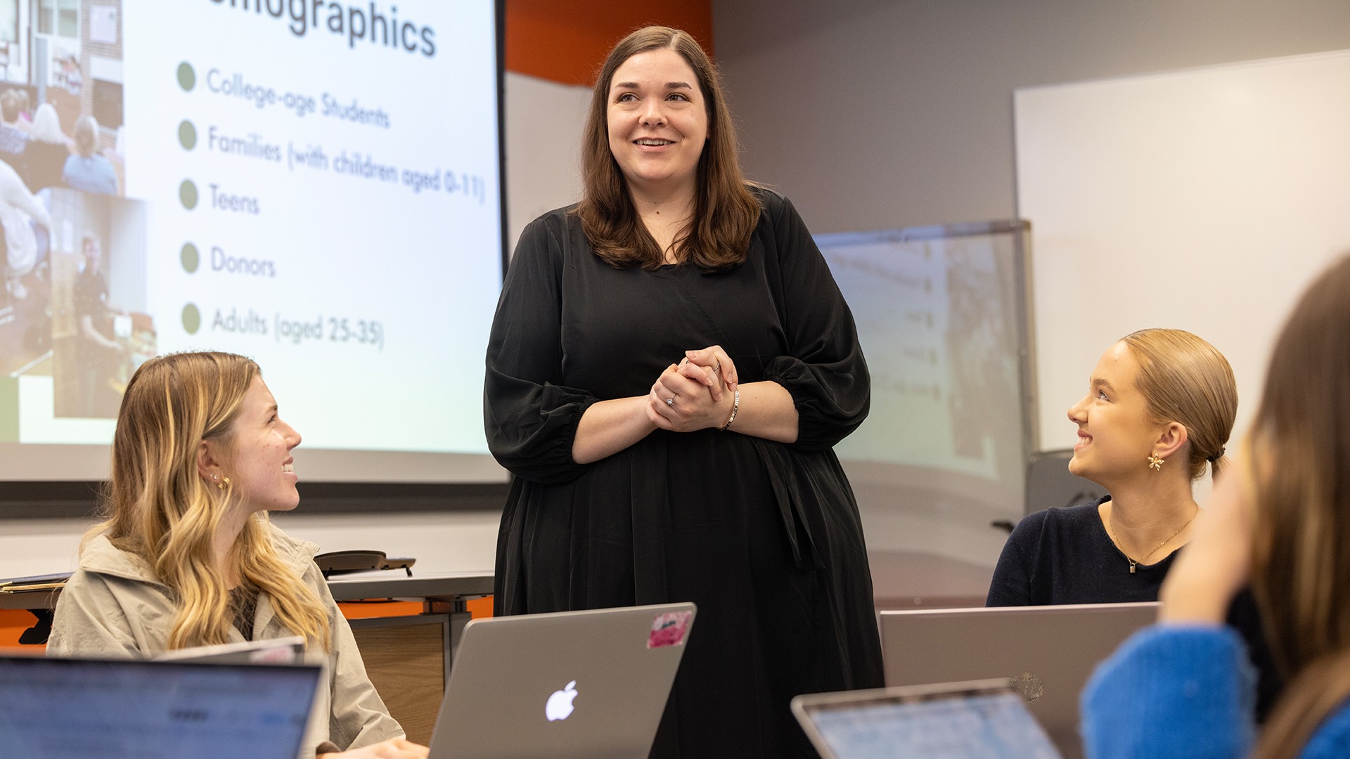 A person speaks to students in a class.