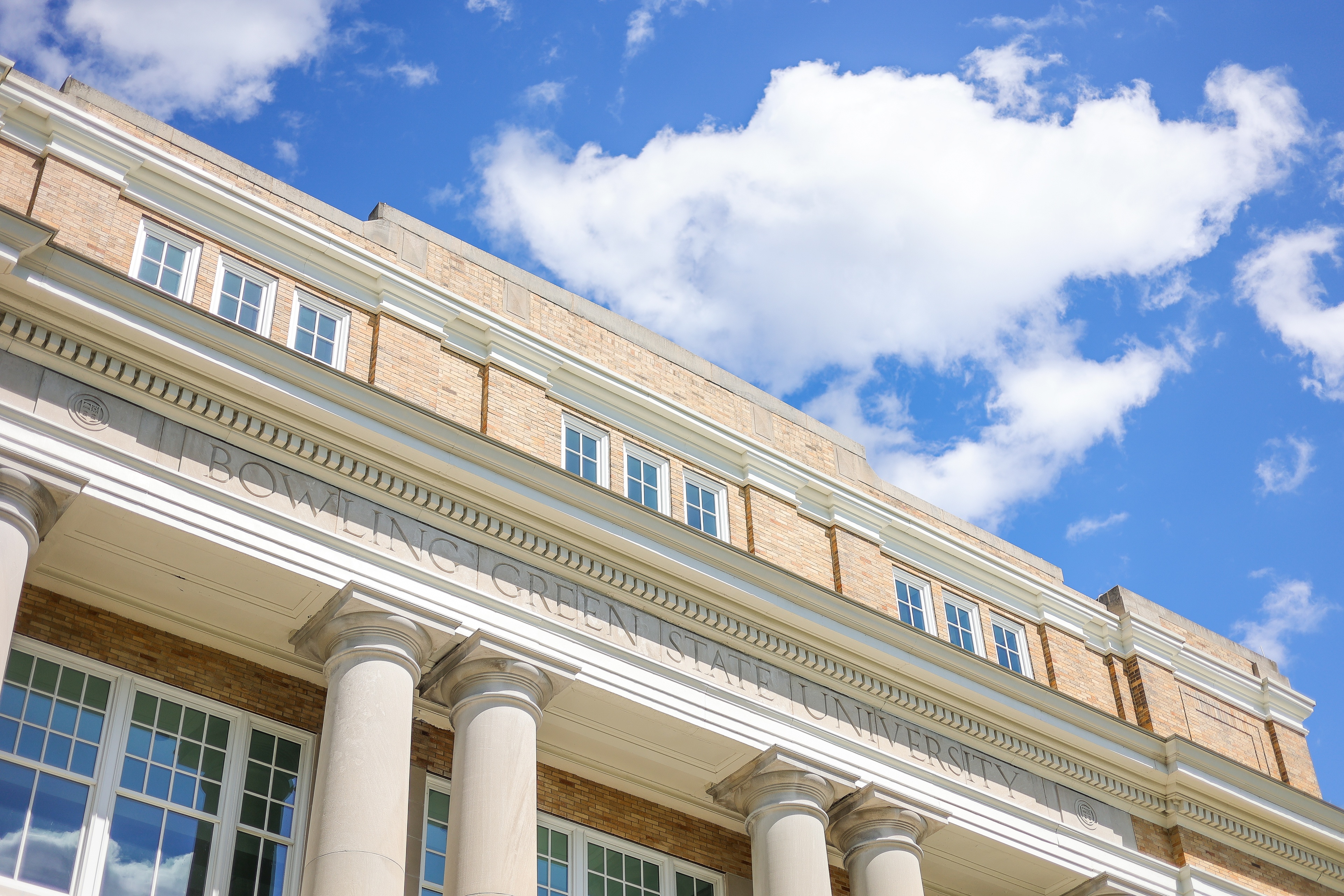 University Hall on the BGSU campus with a blue sky and white clouds in the background.