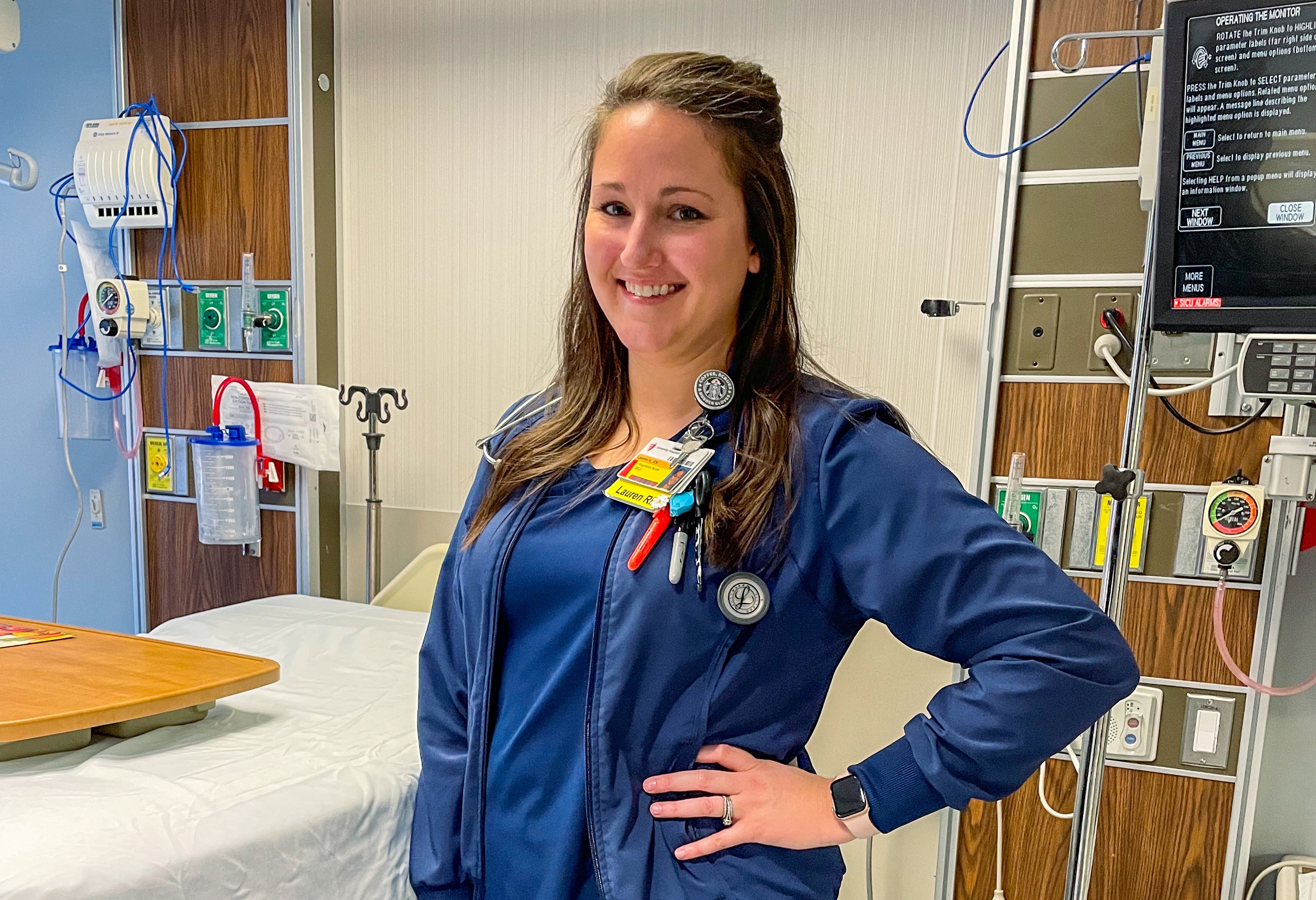 BGSU alumna Lauren Hyde stands in a hospital room during a shift as an intensive-care nurse.