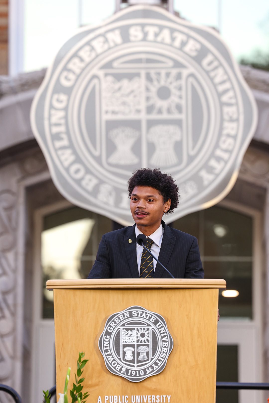 Jayden Donald speaks at a podium.