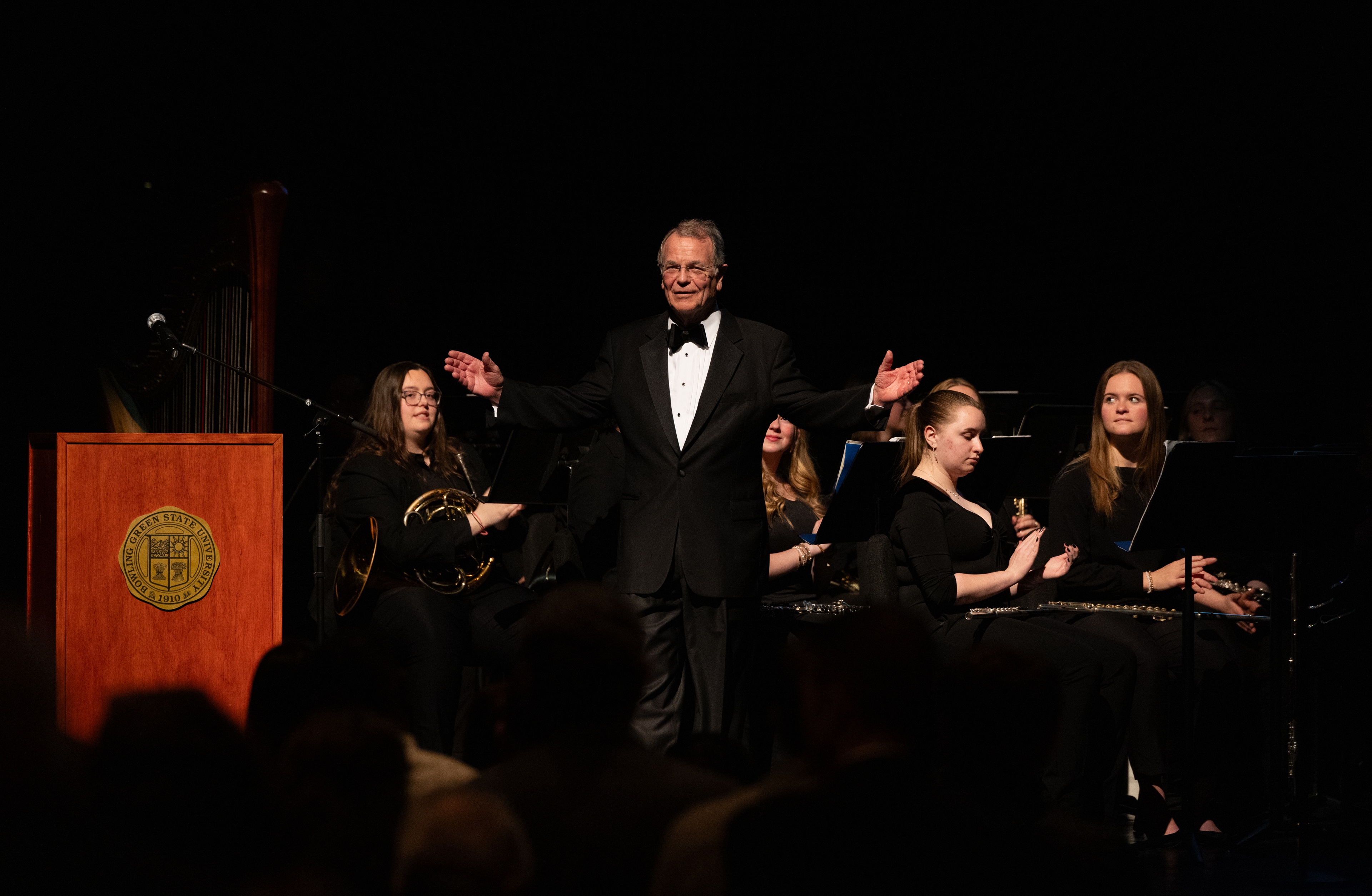 Man in a tuxedo smiles on stage