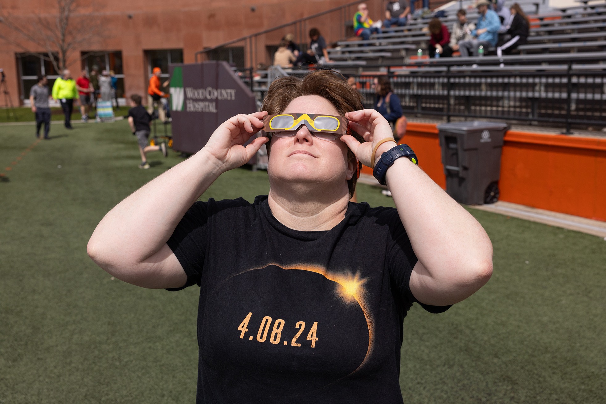 Dr. Kate Dellenbusch wears eclipse glasses
