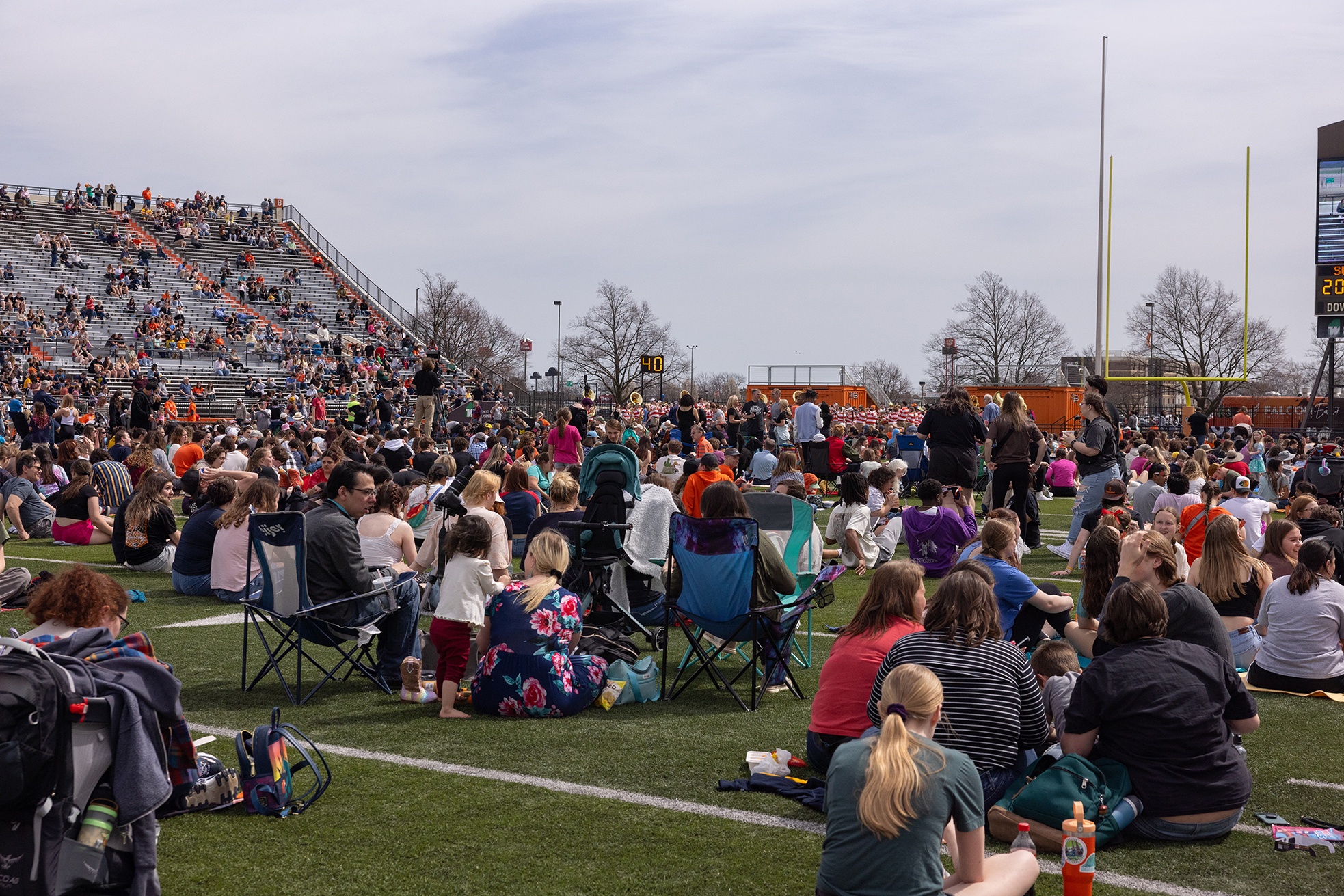 People in lawnchairs and blankets fill the field at Doyt L. Perry Stadium