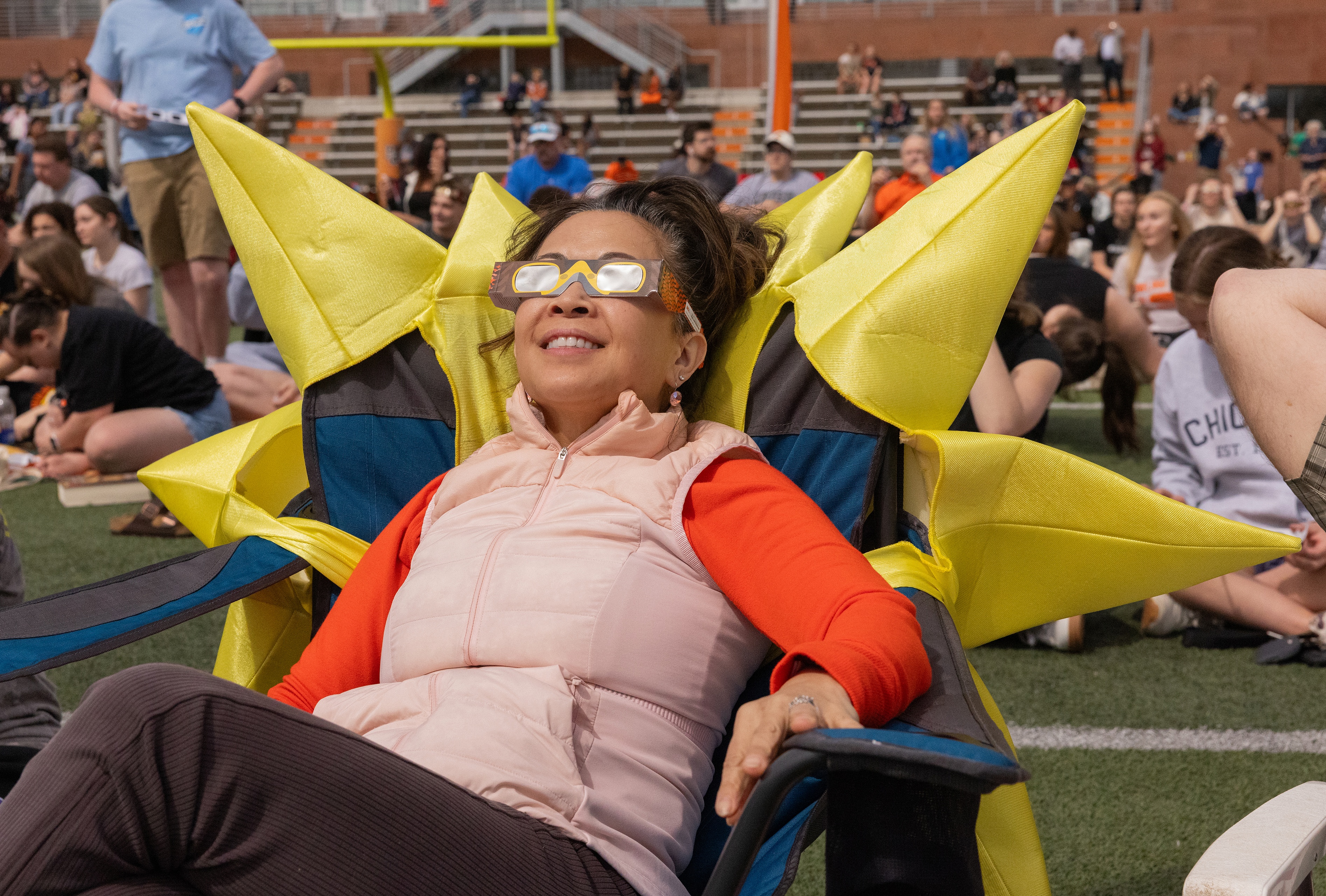 A visitor lounges in a "sun chair" on the field. 