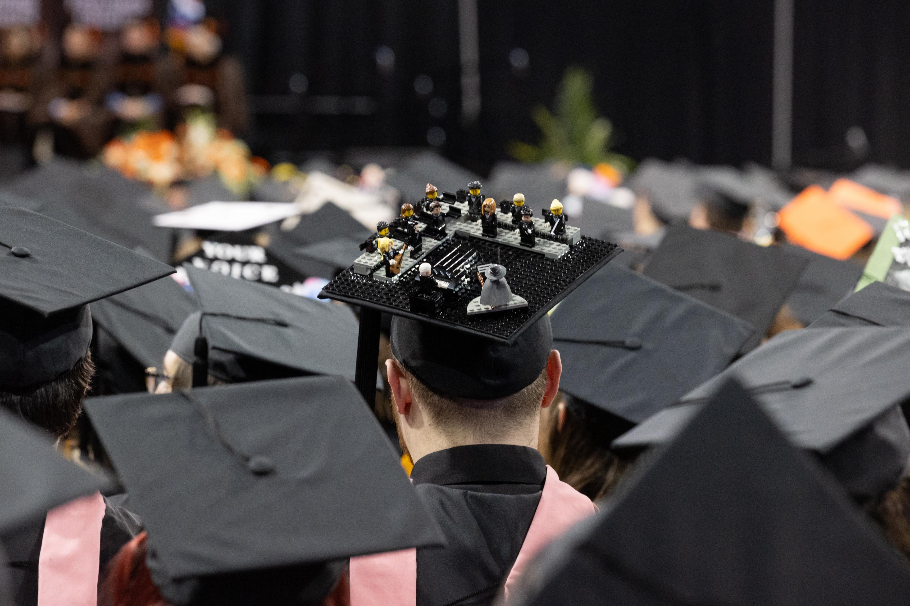 Graduation cap has Lego musicians arrayed on the top