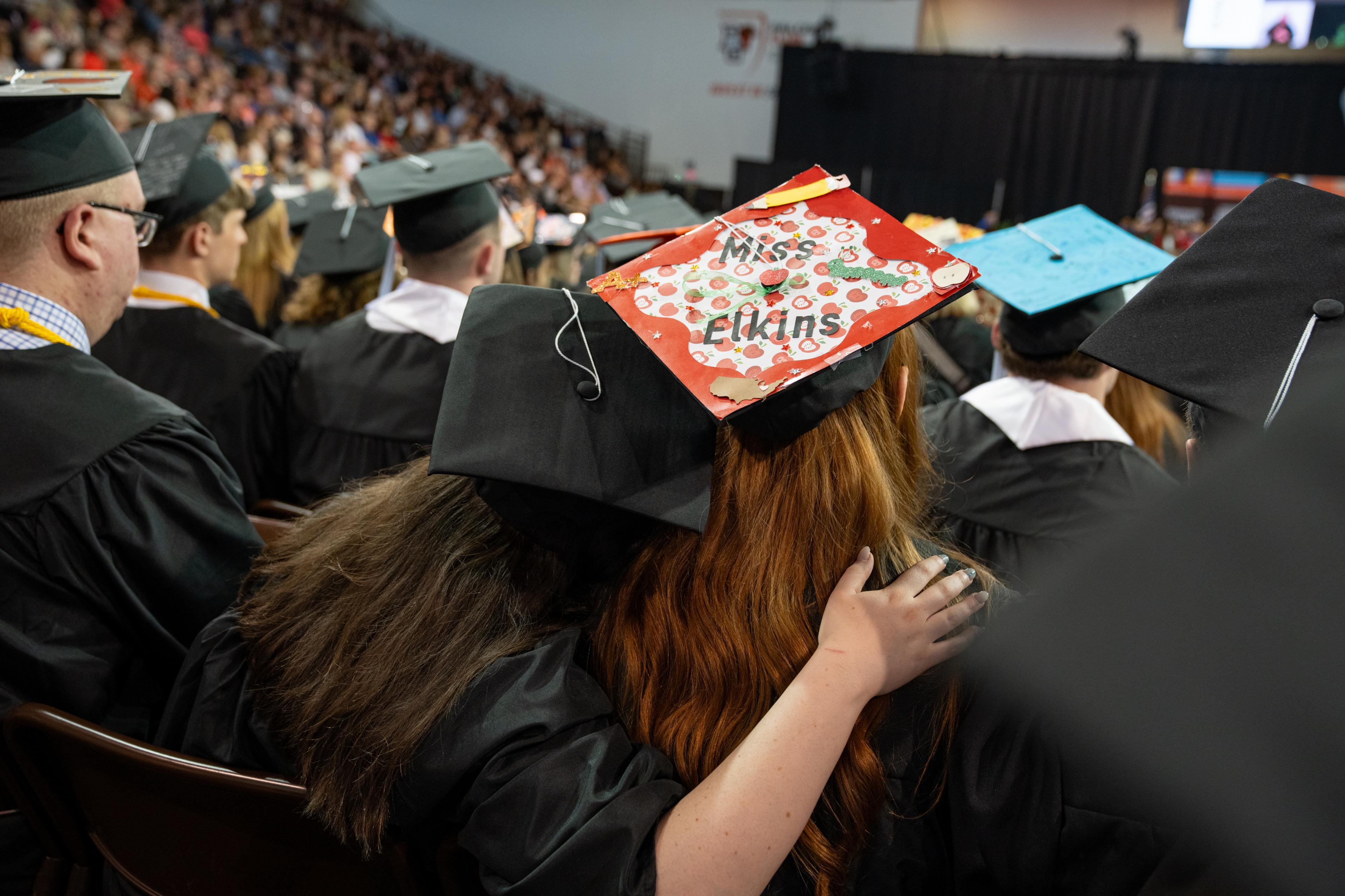 Graduation cap of a future teacher says “Miss Elkins”