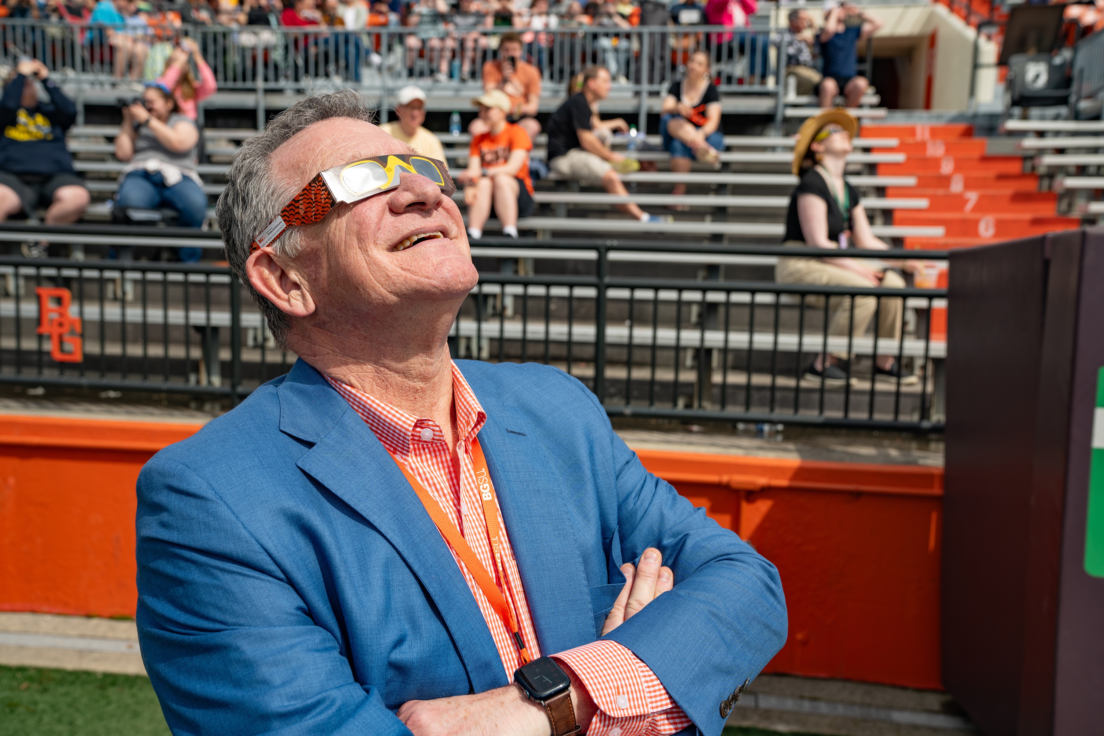BGSU President Rodney K. Rogers checks out the view of the sun through his Falcon-themed eclipse glasses. 