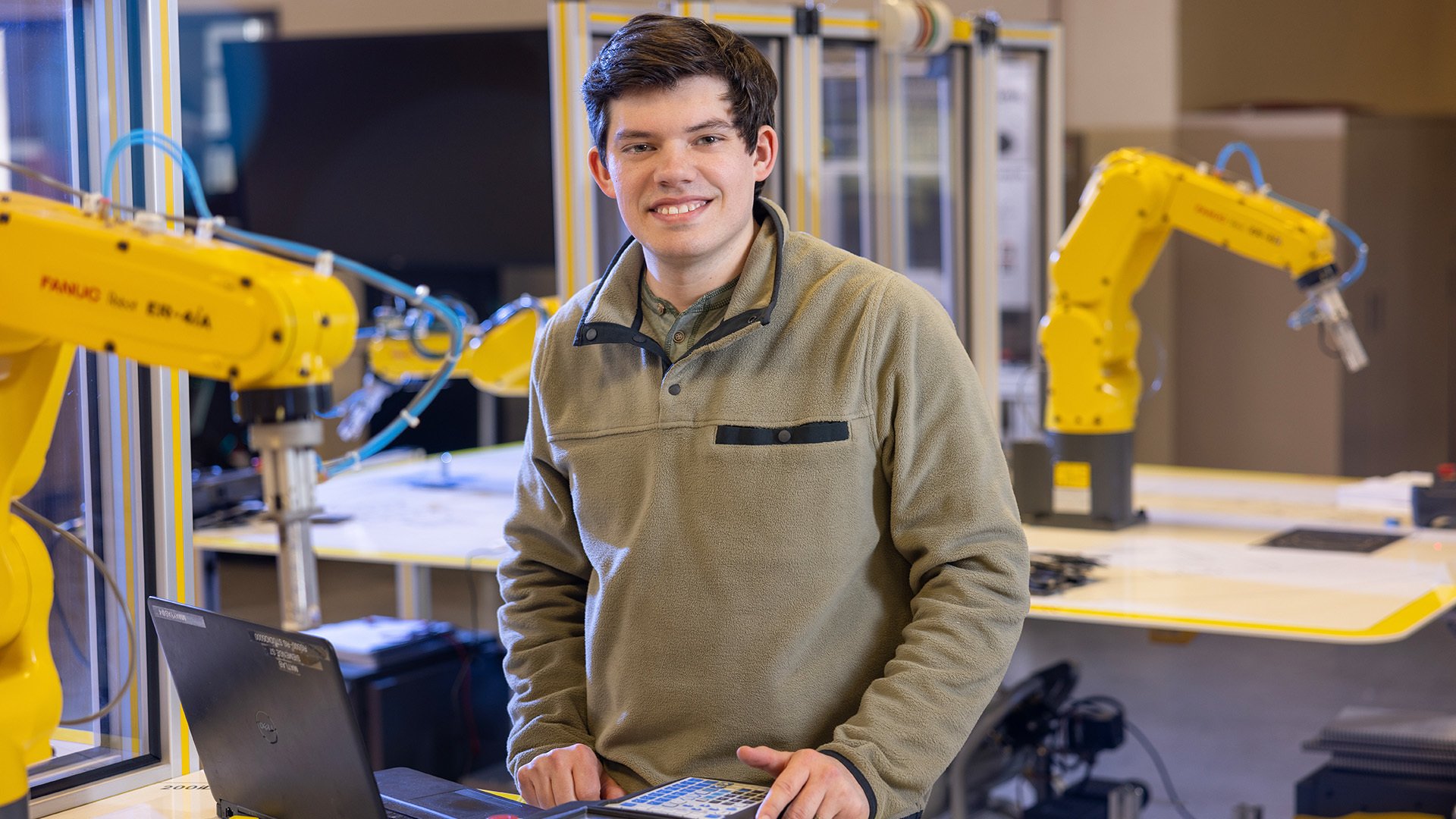 A person stands in a robotics lab at BGSU.