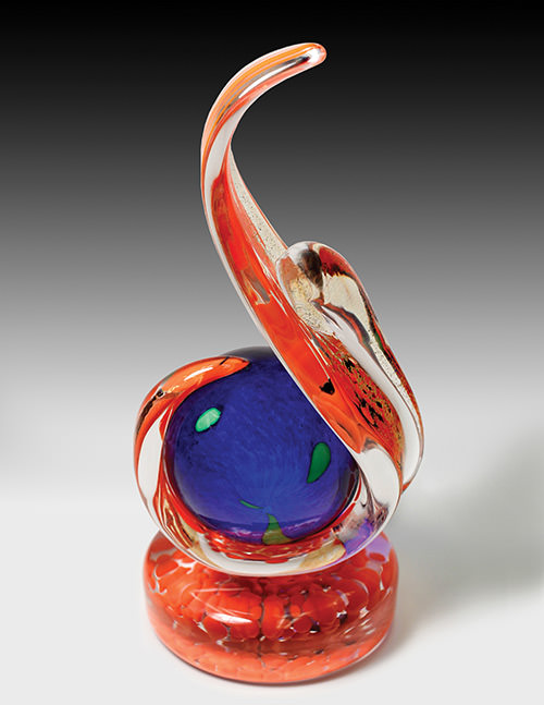 Blue and red glass award in the shape of a music note.
