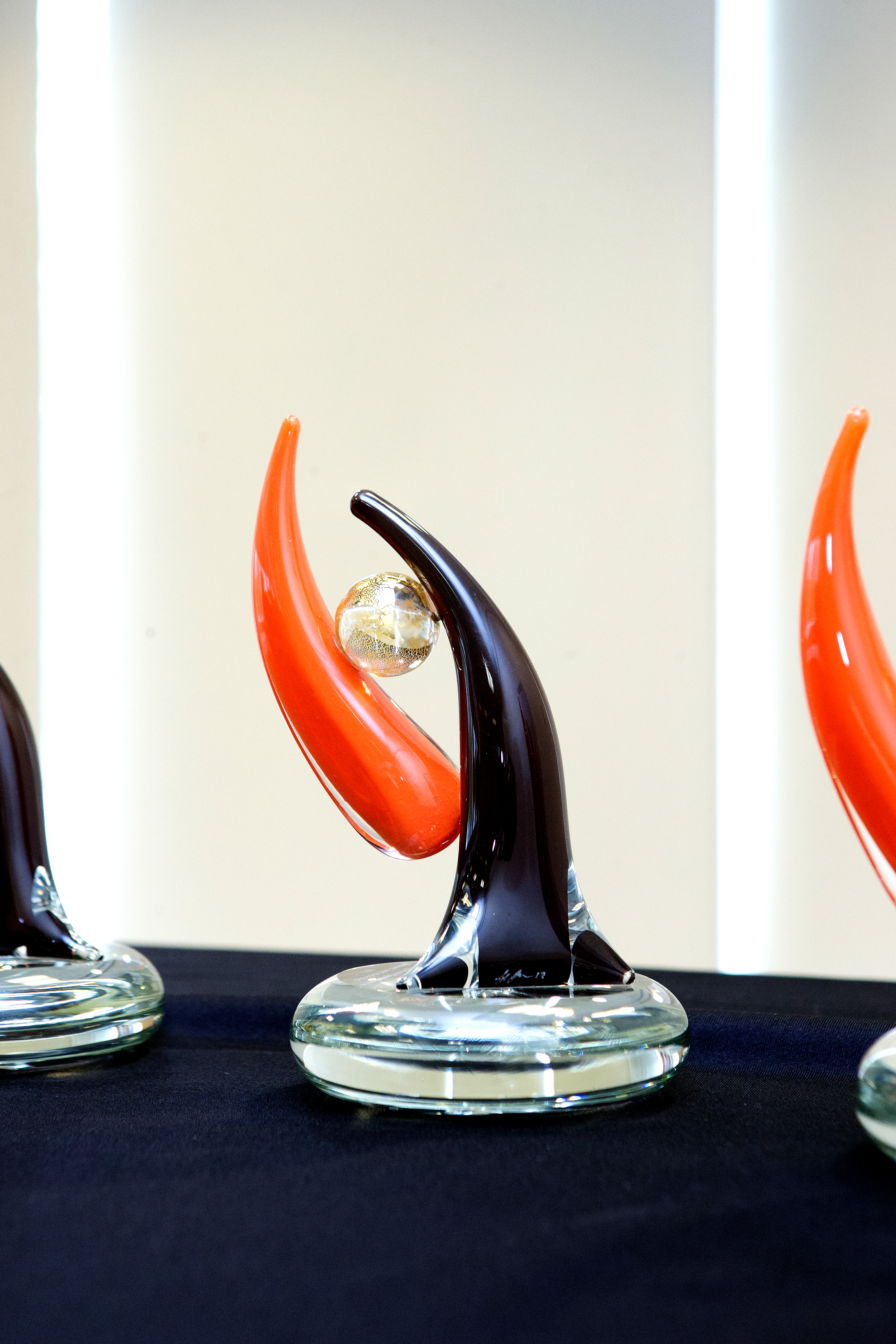 Orange and dark brown pointed glass award.