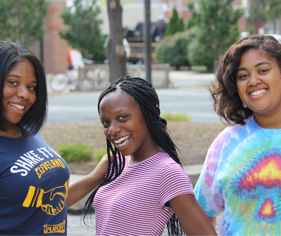 Three female students smiling at the camera